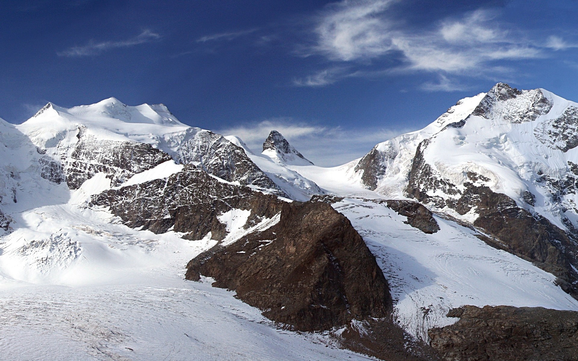 Snow-covered mountains under a blue sky HD Wallpaper