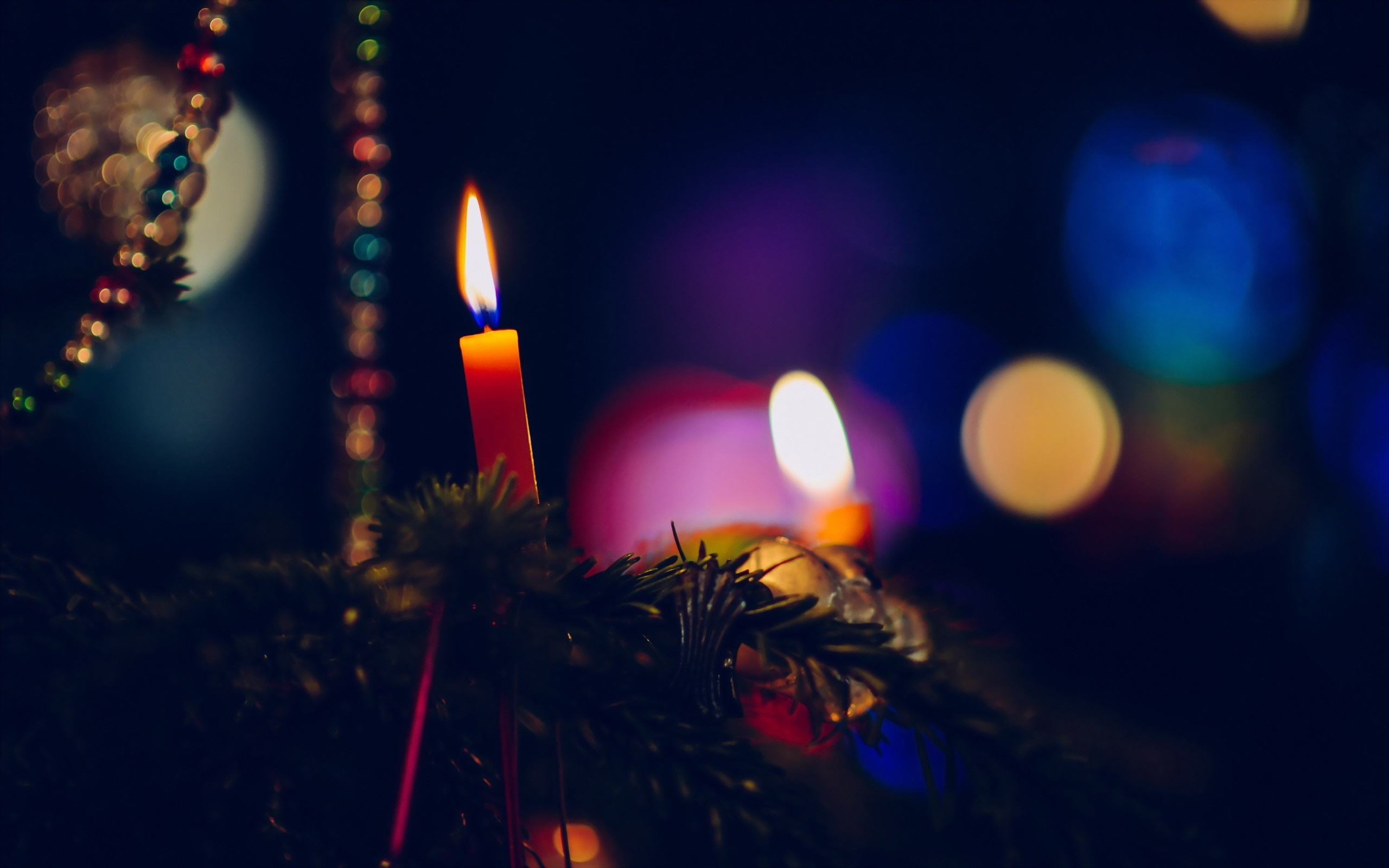 Candle on a Christmas tree with bokeh lights HD Wallpaper