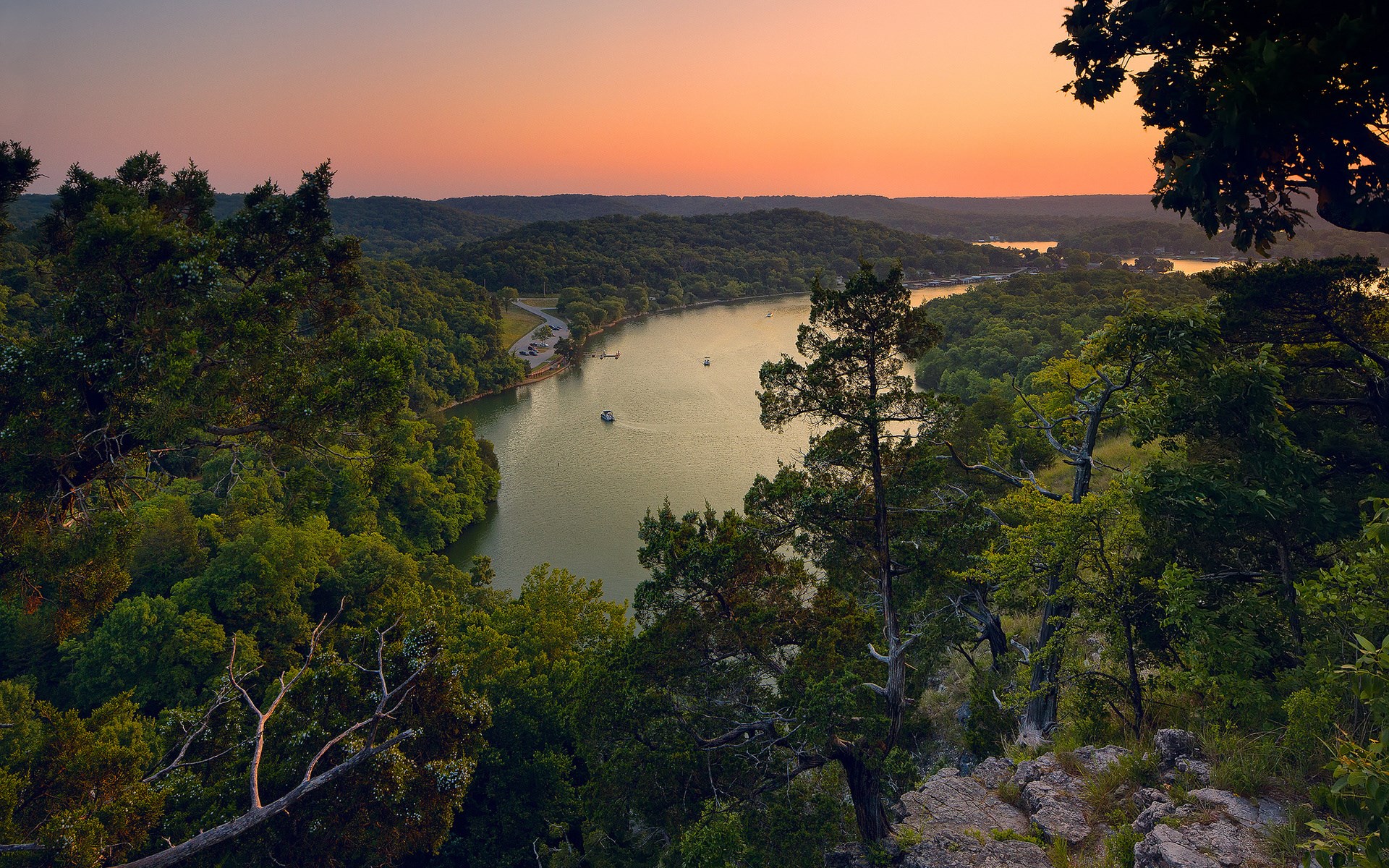 Sunset over a winding river and forested hills HD Wallpaper