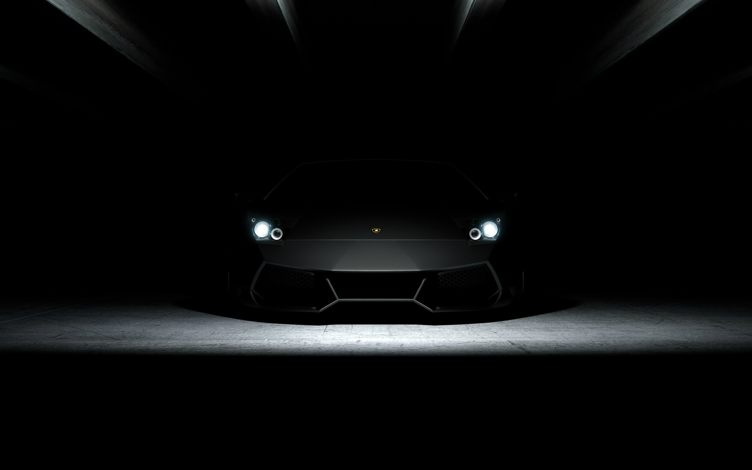 Black Lamborghini sports car in a dark setting HD Wallpaper