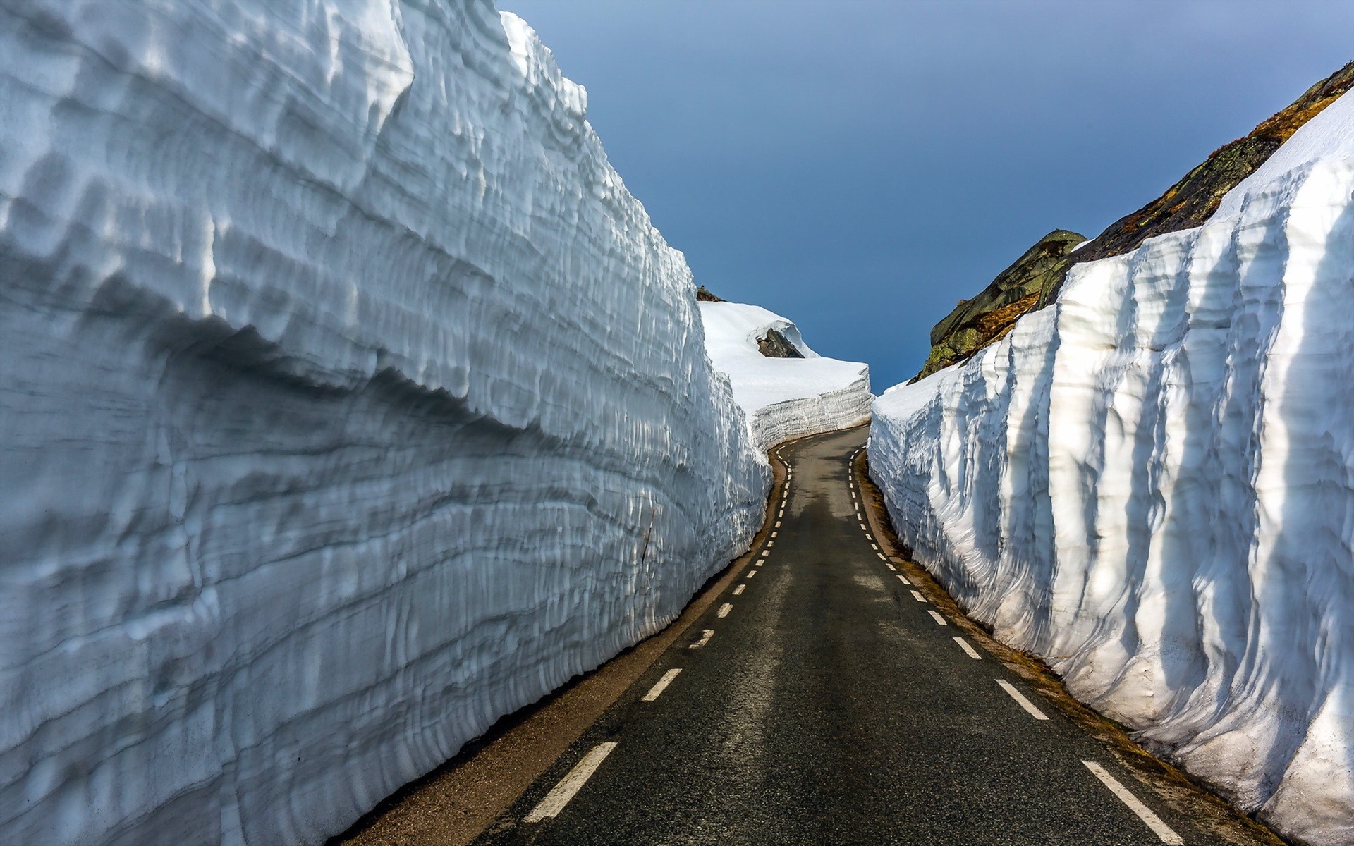 Road through snow walls in mountains HD Wallpaper