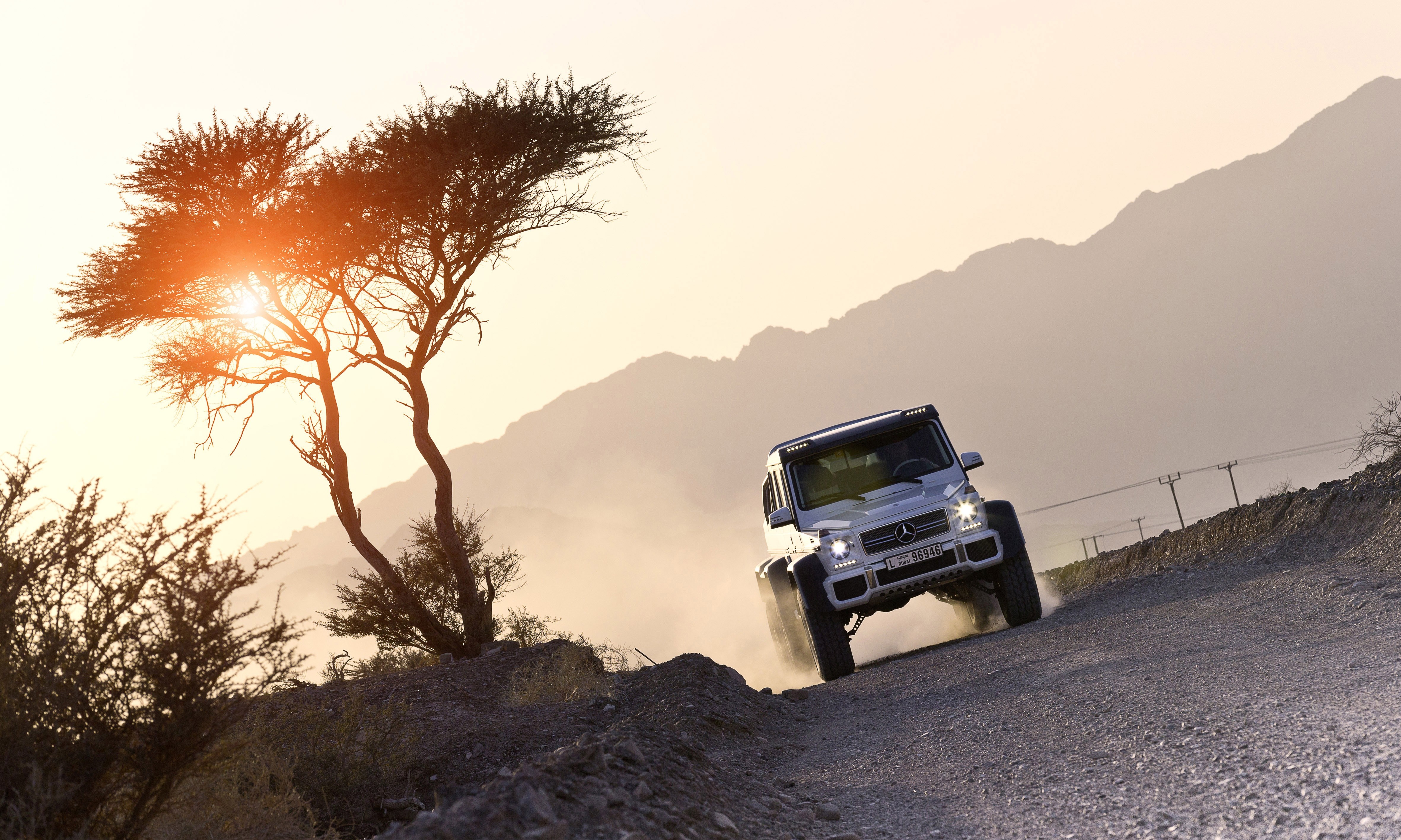 Mercedes-Benz G63 AMG 6x6 off-roading in desert landscape HD Wallpaper