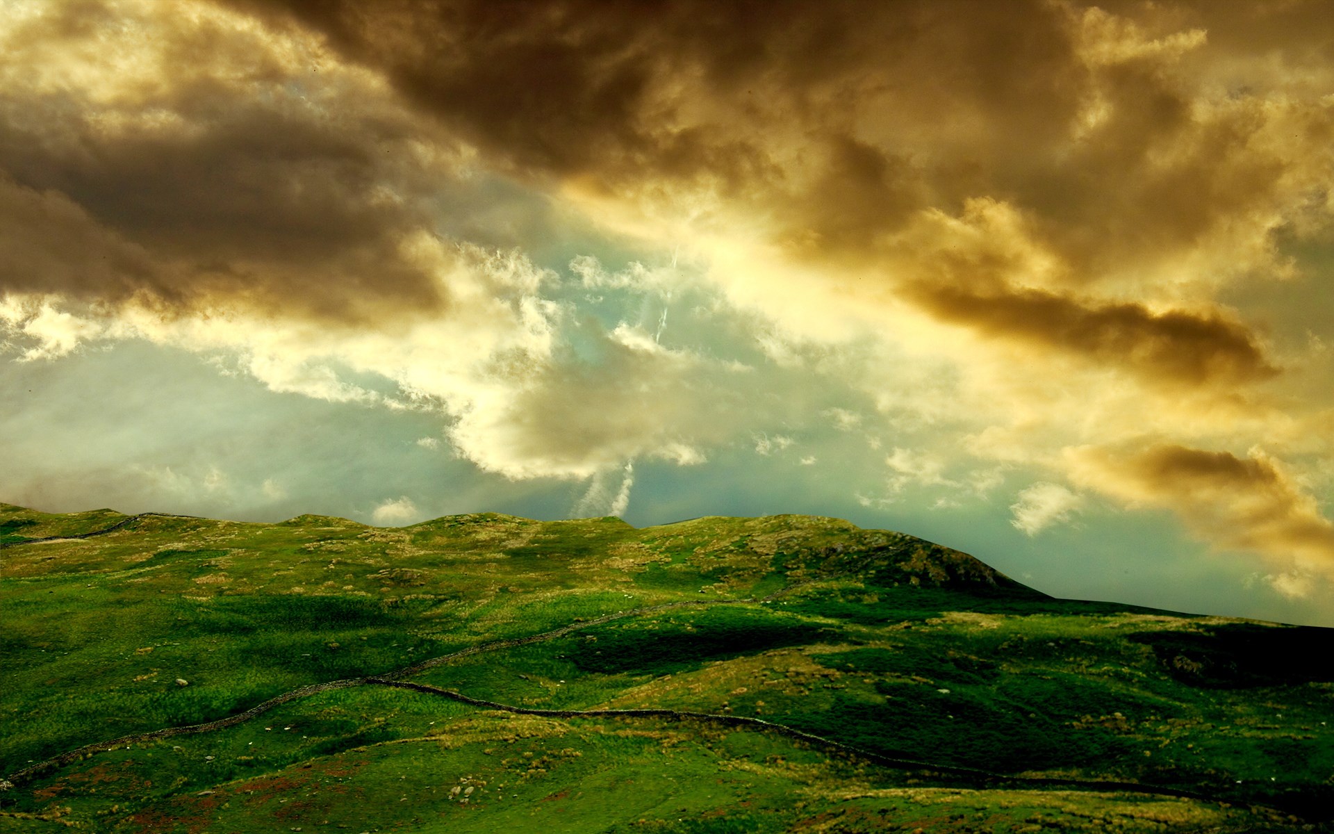 Green rolling hills under dramatic cloudy sky HD Wallpaper