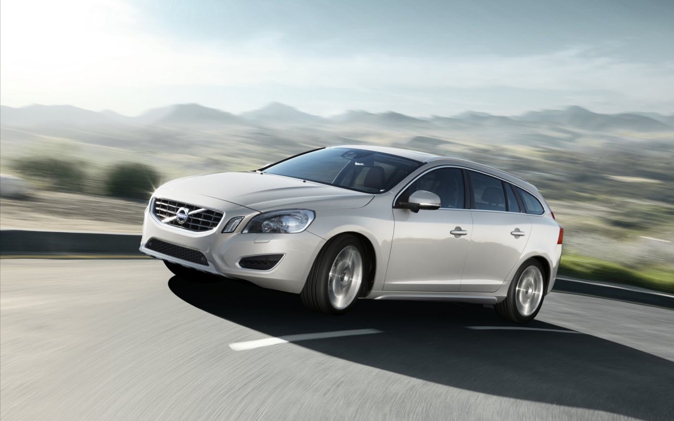 Silver Volvo V60 Wagon driving on a winding road HD Wallpaper