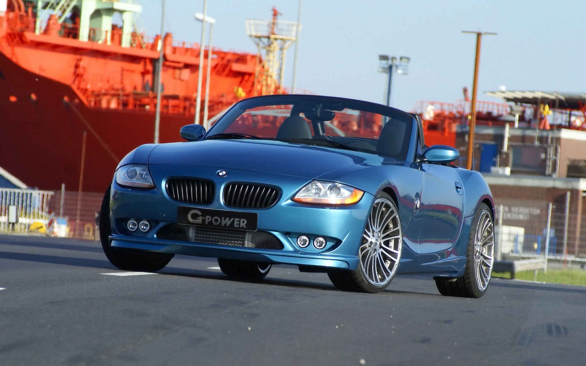 Blue G-Power BMW Z4 Convertible parked by a large ship HD Wallpaper