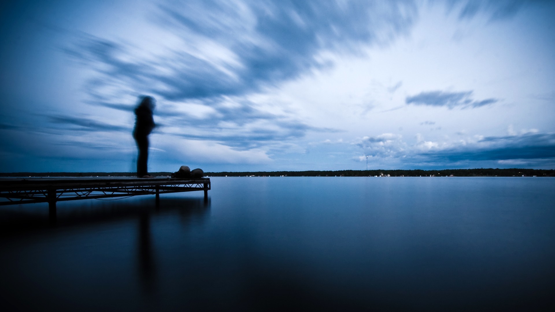 Person on a dock over a calm lake at dusk HD Wallpaper