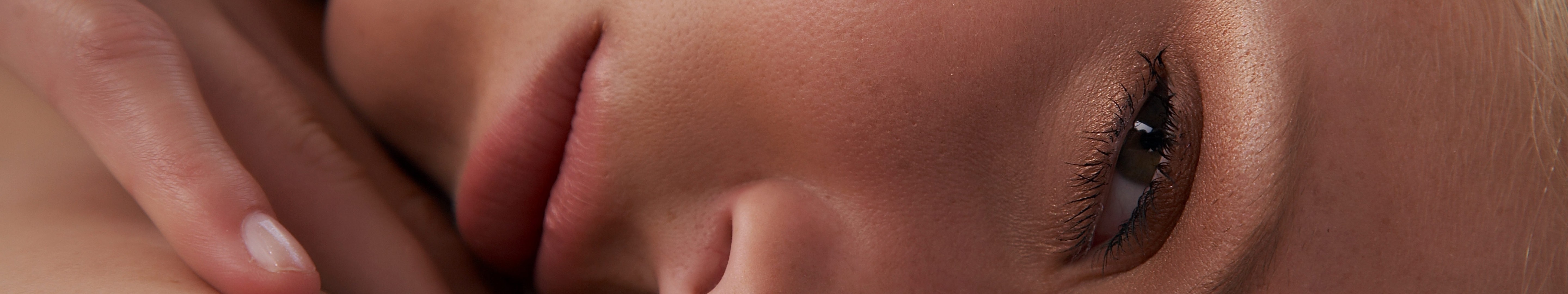 Close up of a woman's face with hand HD Wallpaper