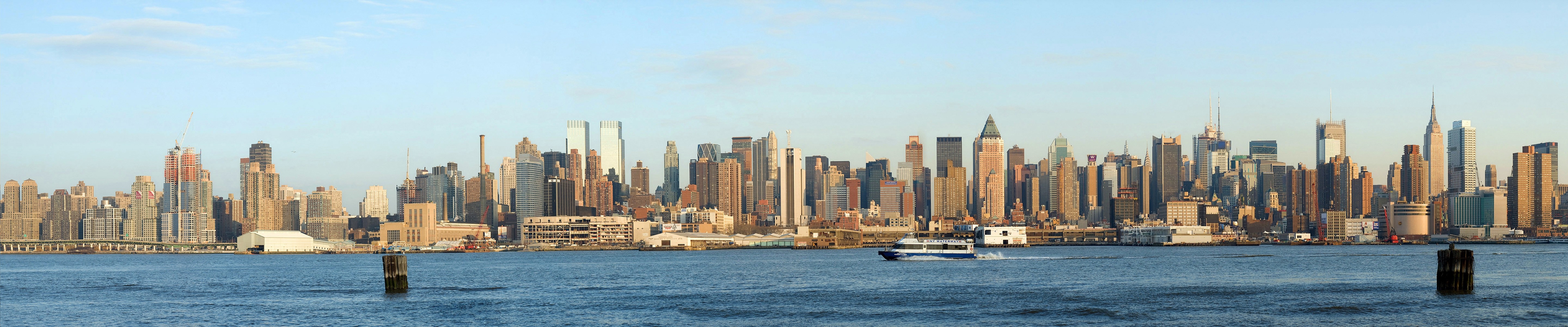 New York City skyline panorama with a boat on the water HD Wallpaper