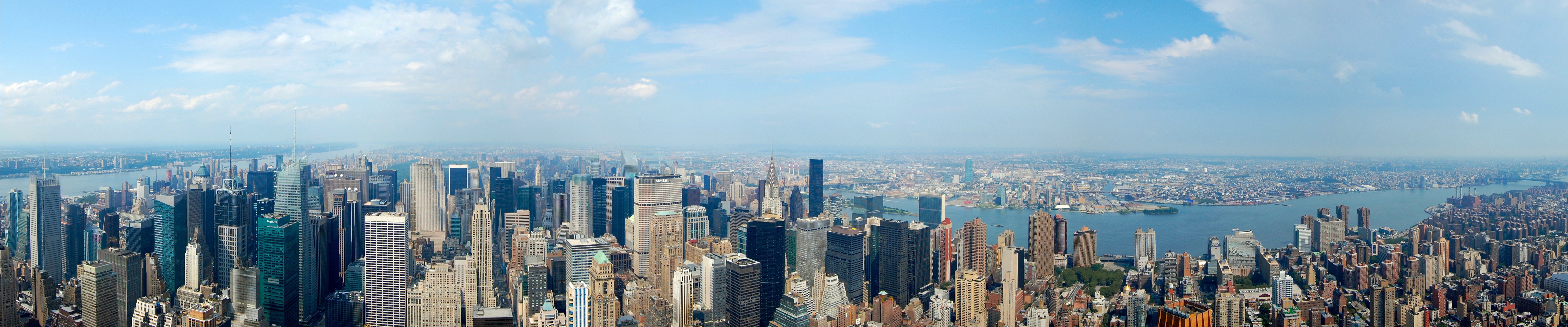 Panoramic view of New York City skyline with skyscrapers and water HD Wallpaper