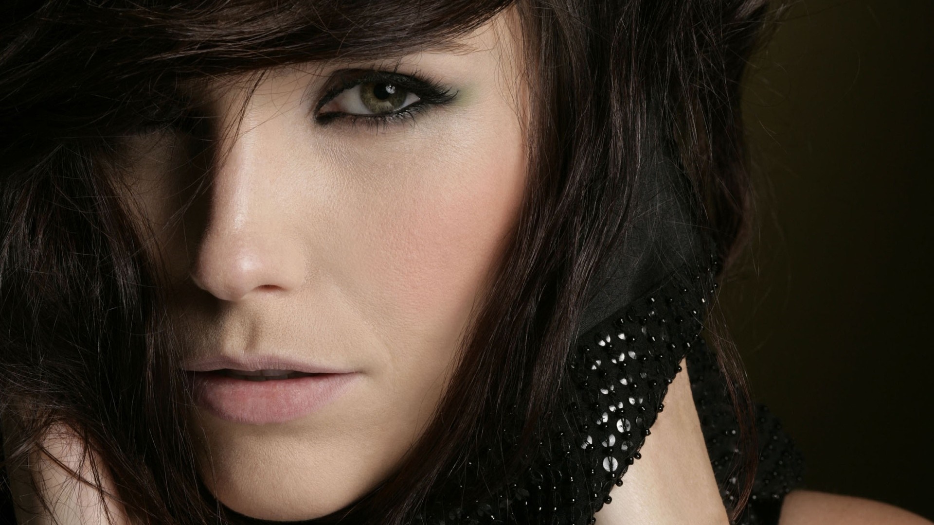 Woman with dark hair and green eyes, close-up portrait HD Wallpaper