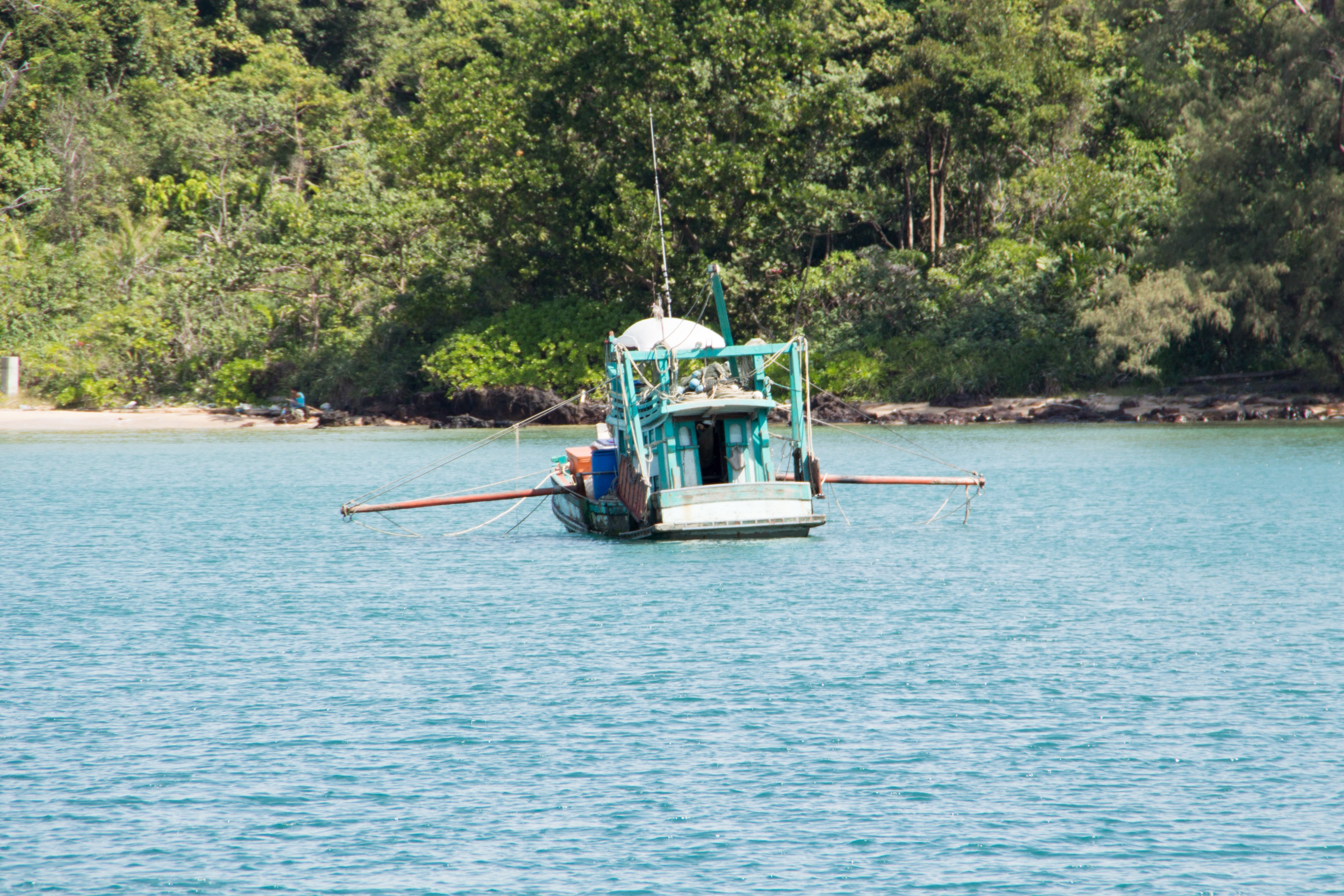 Fishing boat on the water near a tropical island HD Wallpaper