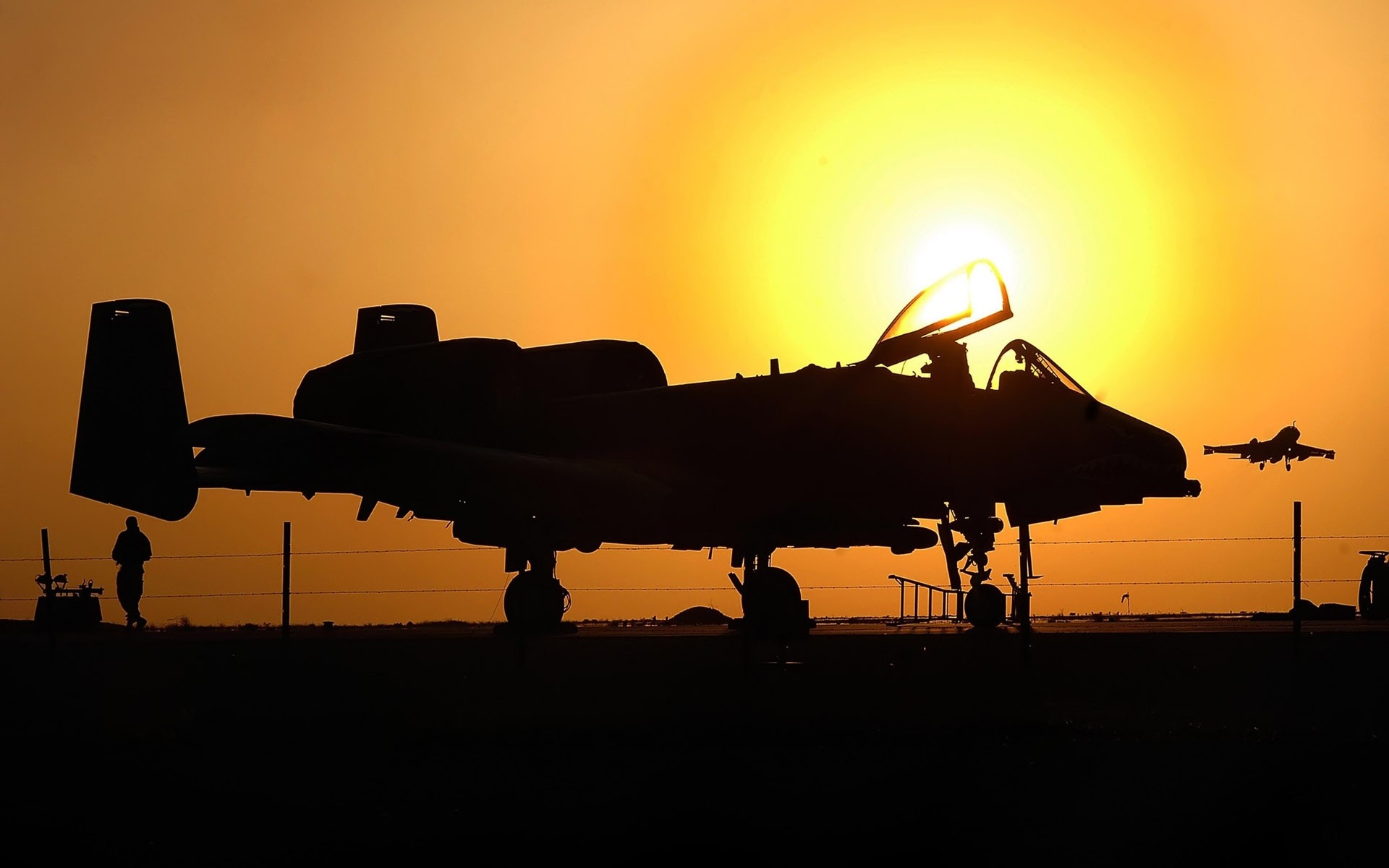 Silhouette of A-10 Thunderbolt II aircraft at sunset HD Wallpaper
