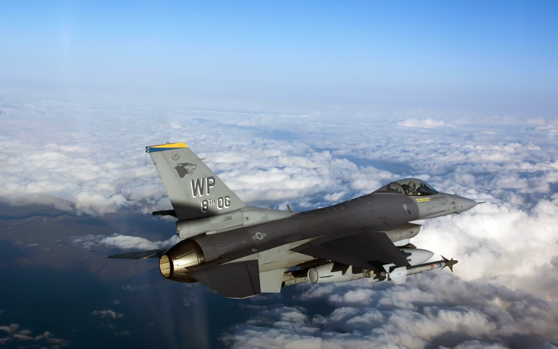 F-16 Fighting Falcon flying over clouds HD Wallpaper