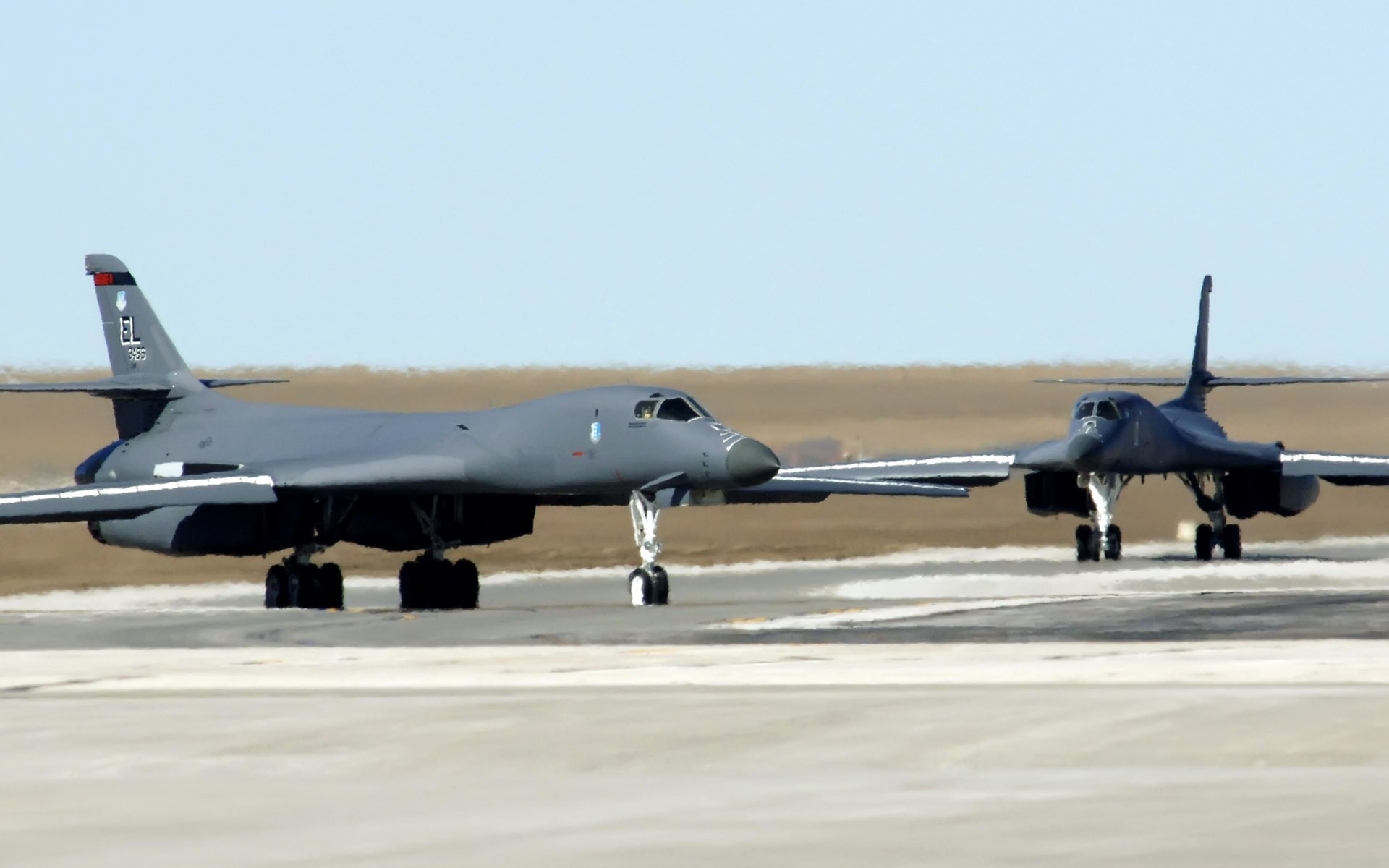 Two Rockwell B-1 Lancer bombers on a runway HD Wallpaper