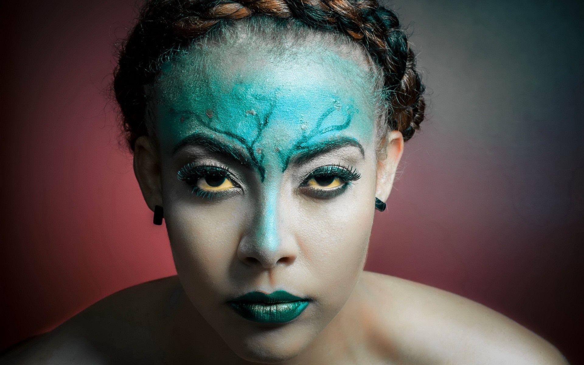 Woman with green and blue face paint and yellow eyes HD Wallpaper