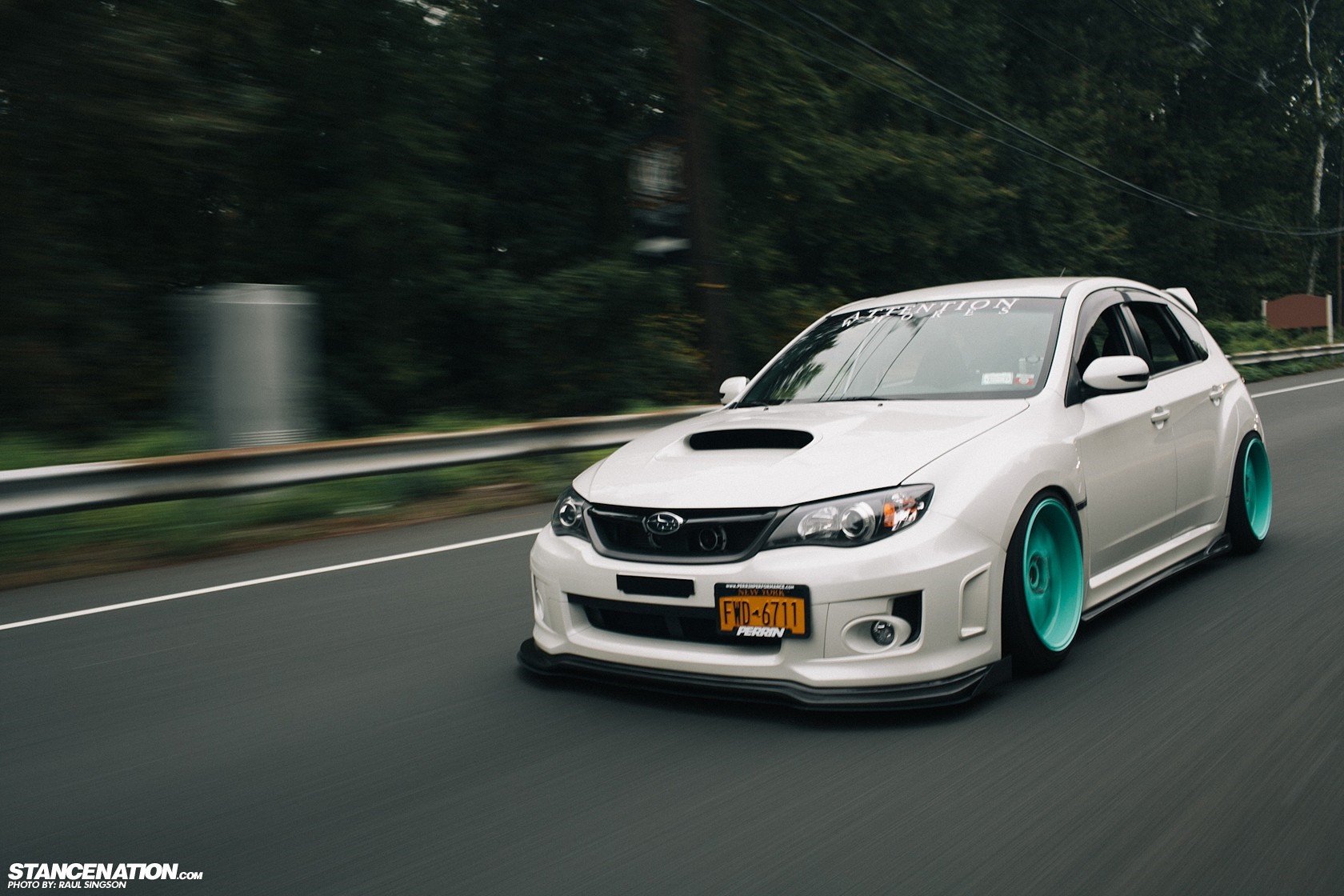White Subaru Impreza WRX STi with teal wheels on a road HD Wallpaper