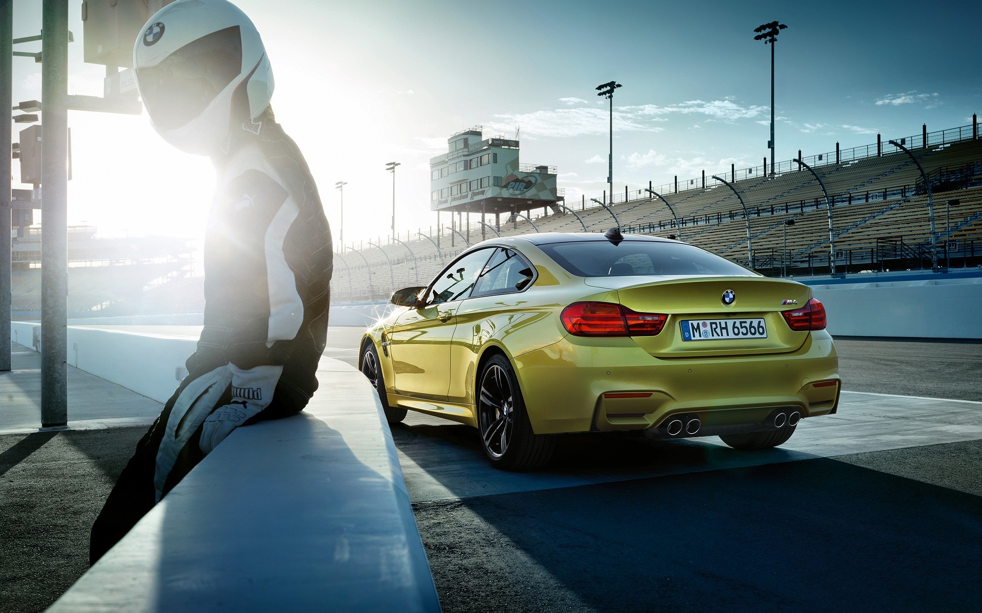 Yellow BMW M4 on a Race Track with a Driver HD Wallpaper