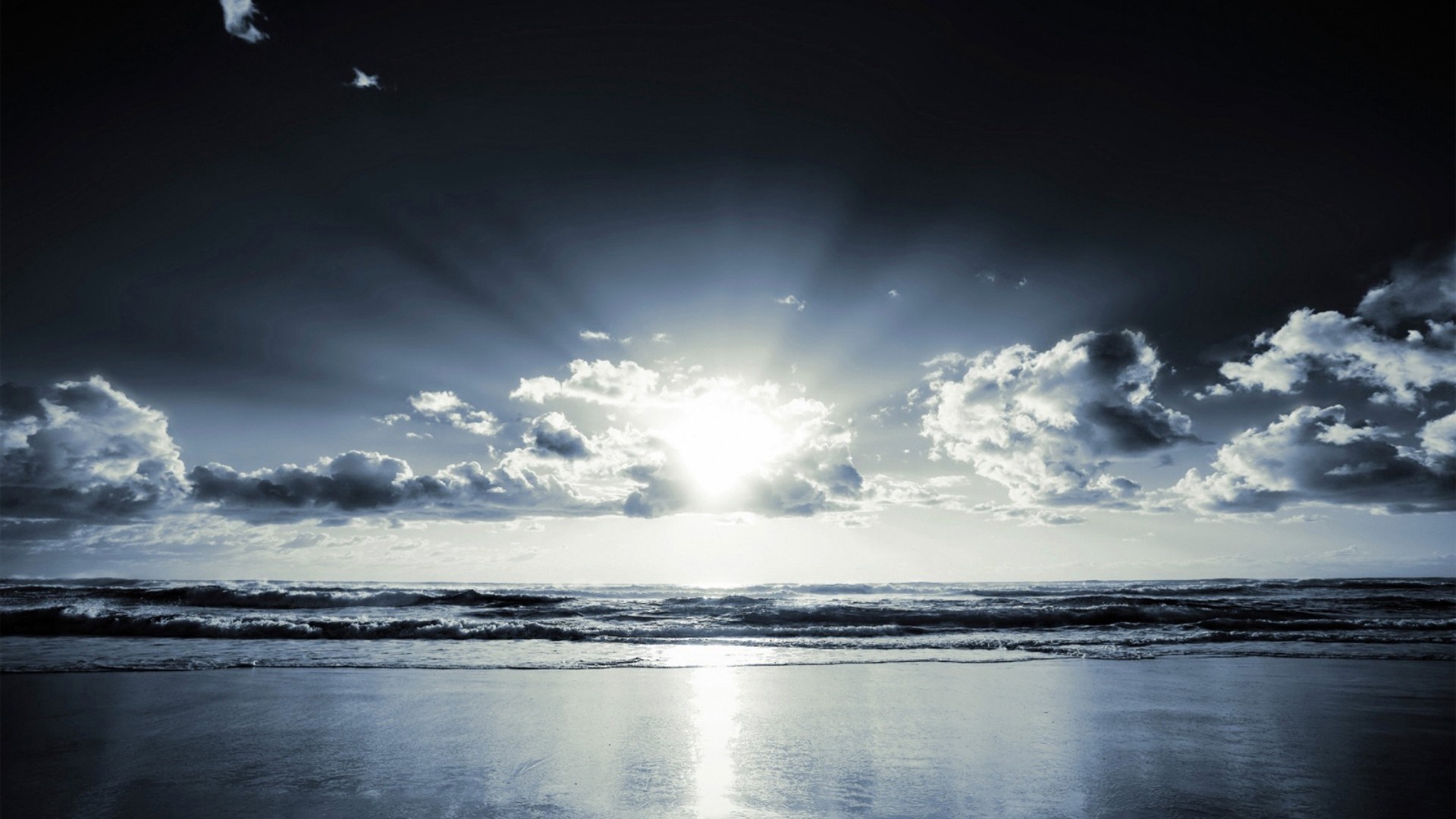 Sunlight breaking through clouds over the ocean at dusk HD Wallpaper