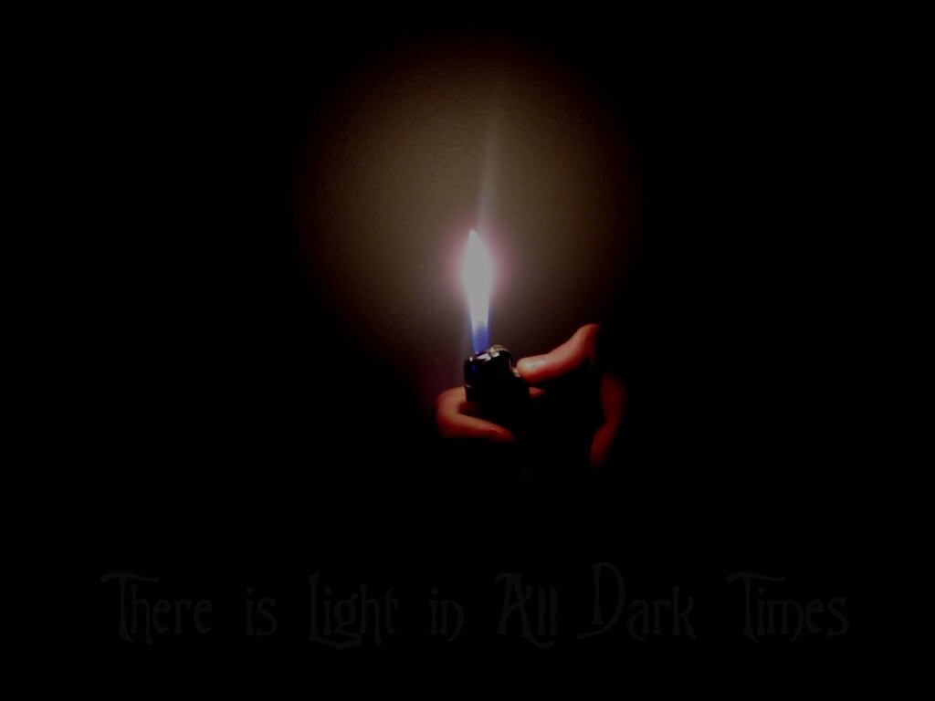 Hand holding a lighter with a flame in the dark HD Wallpaper