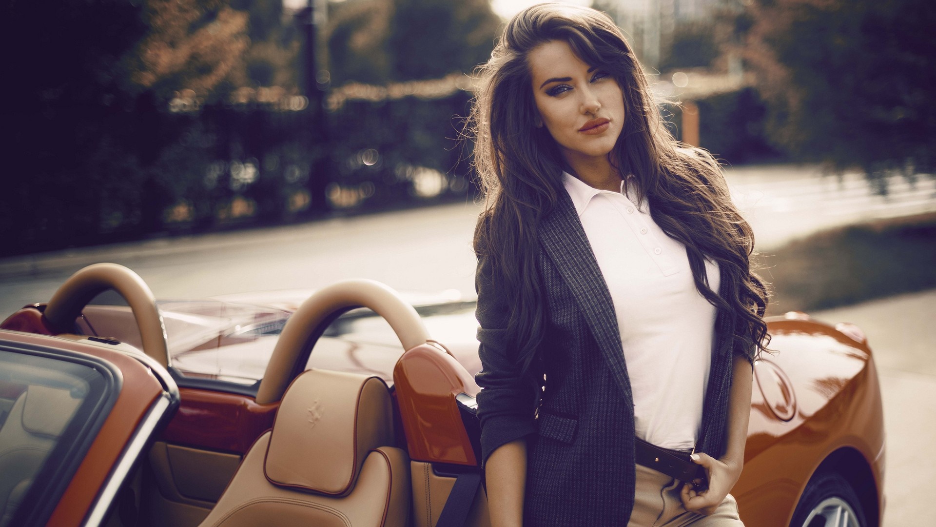 Woman in blazer posing by a red Ferrari convertible HD Wallpaper