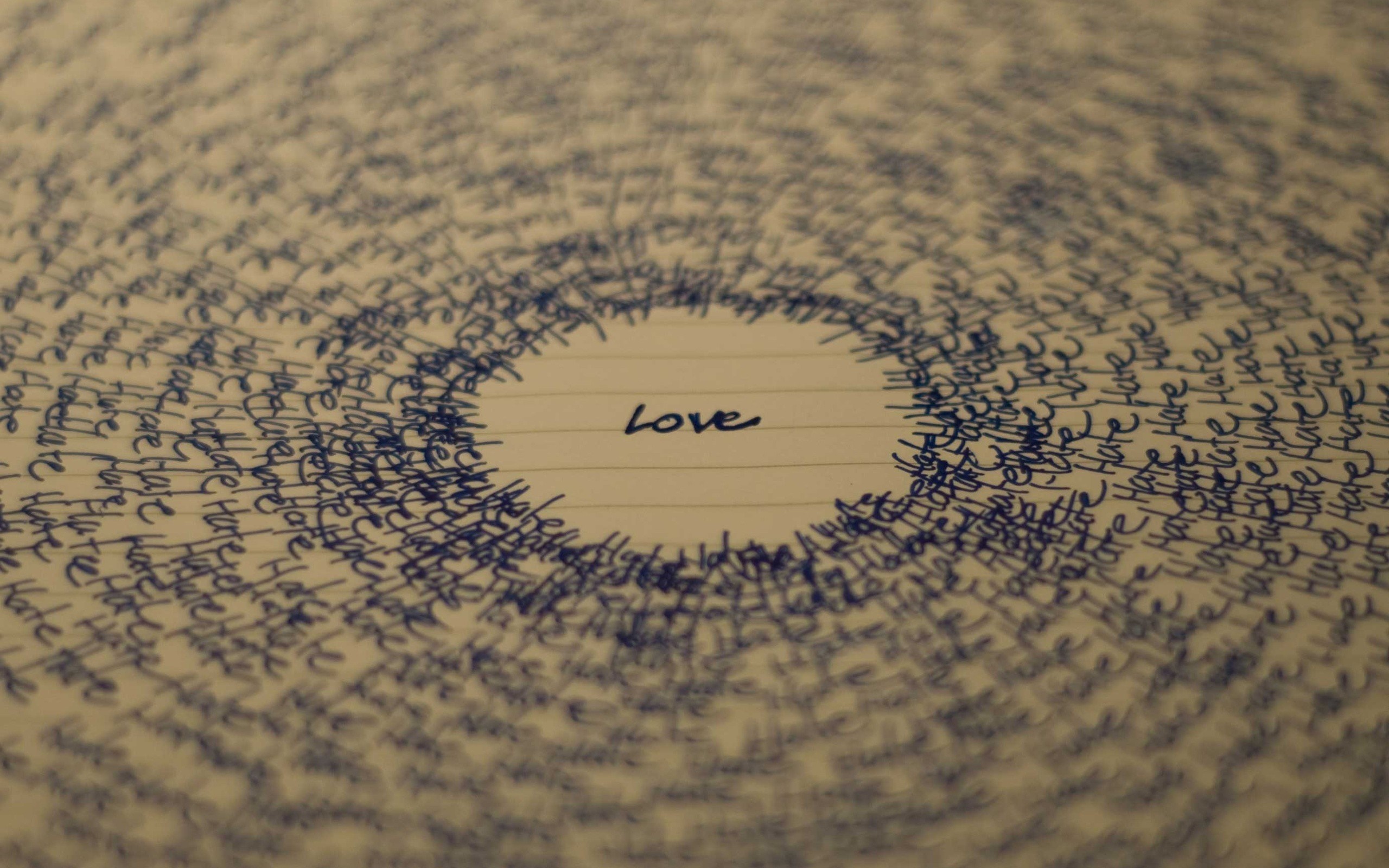Circular text pattern with the word Love in the center HD Wallpaper