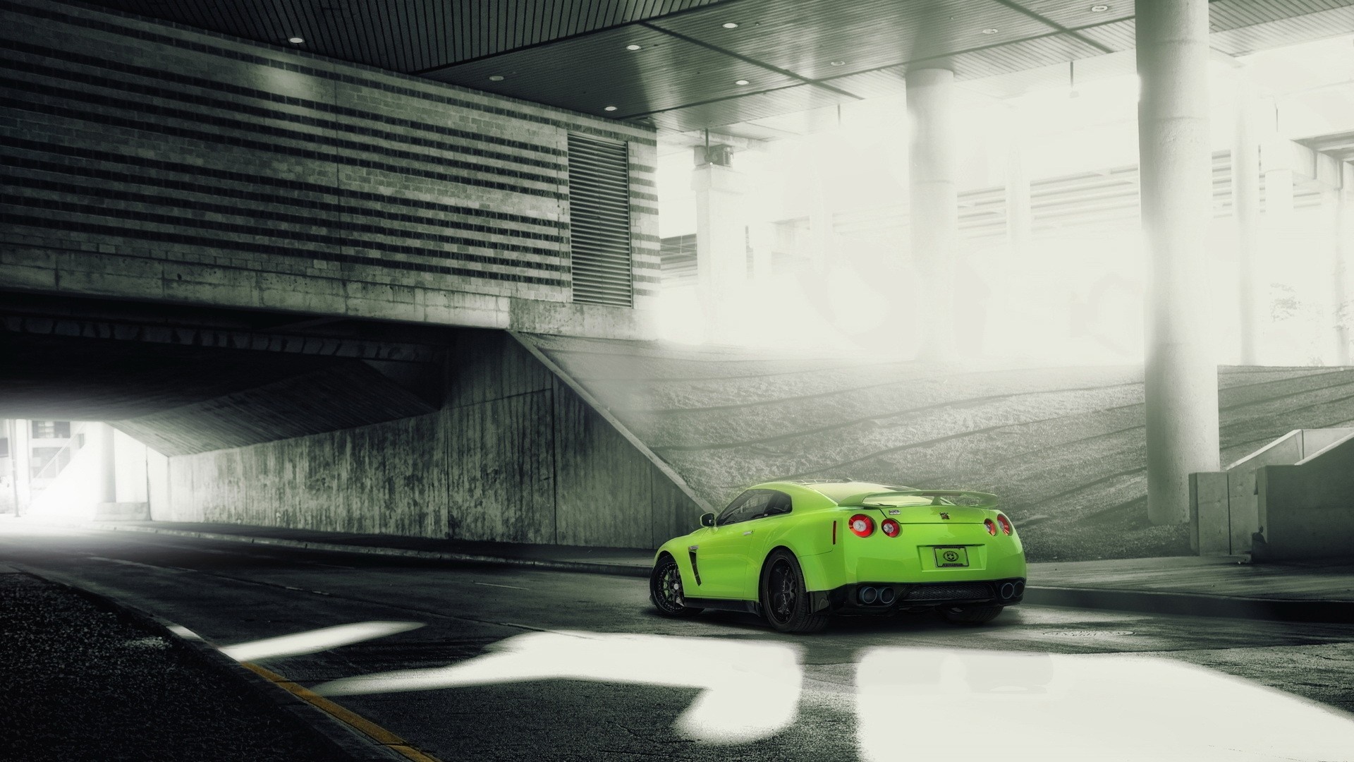 Green Nissan GT-R driving under a concrete structure HD Wallpaper