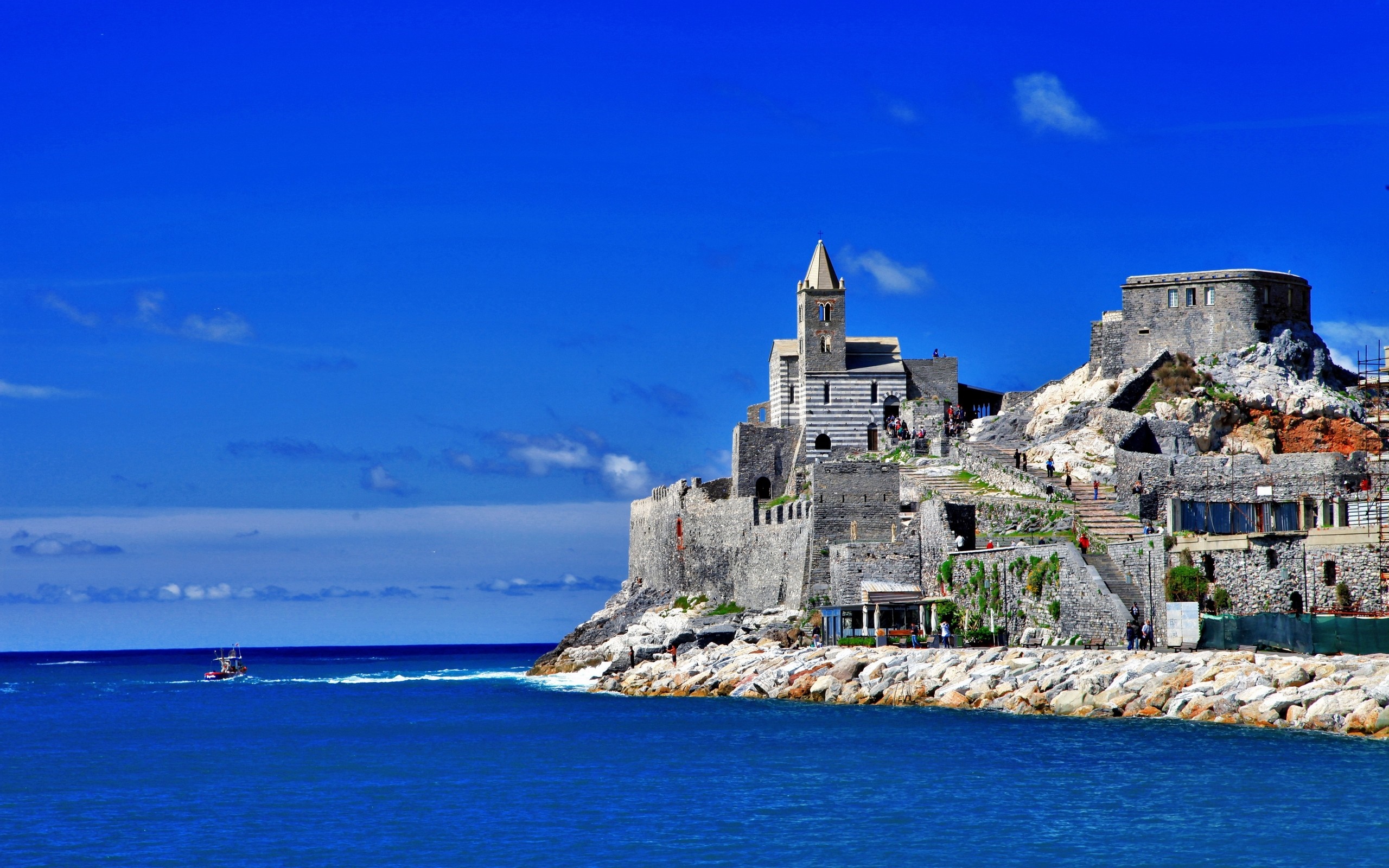 Castle on a rocky coast overlooking the sea HD Wallpaper
