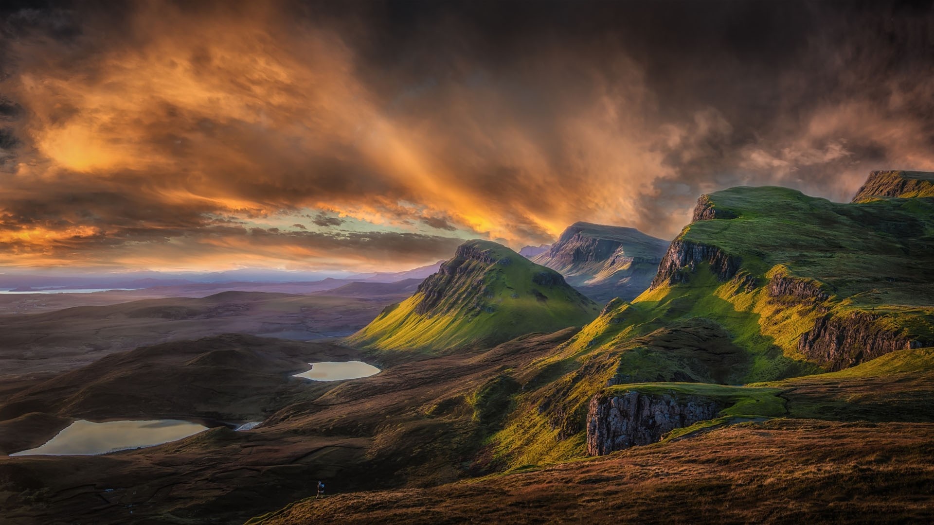 Dramatic sunset over green hills and lochs HD Wallpaper