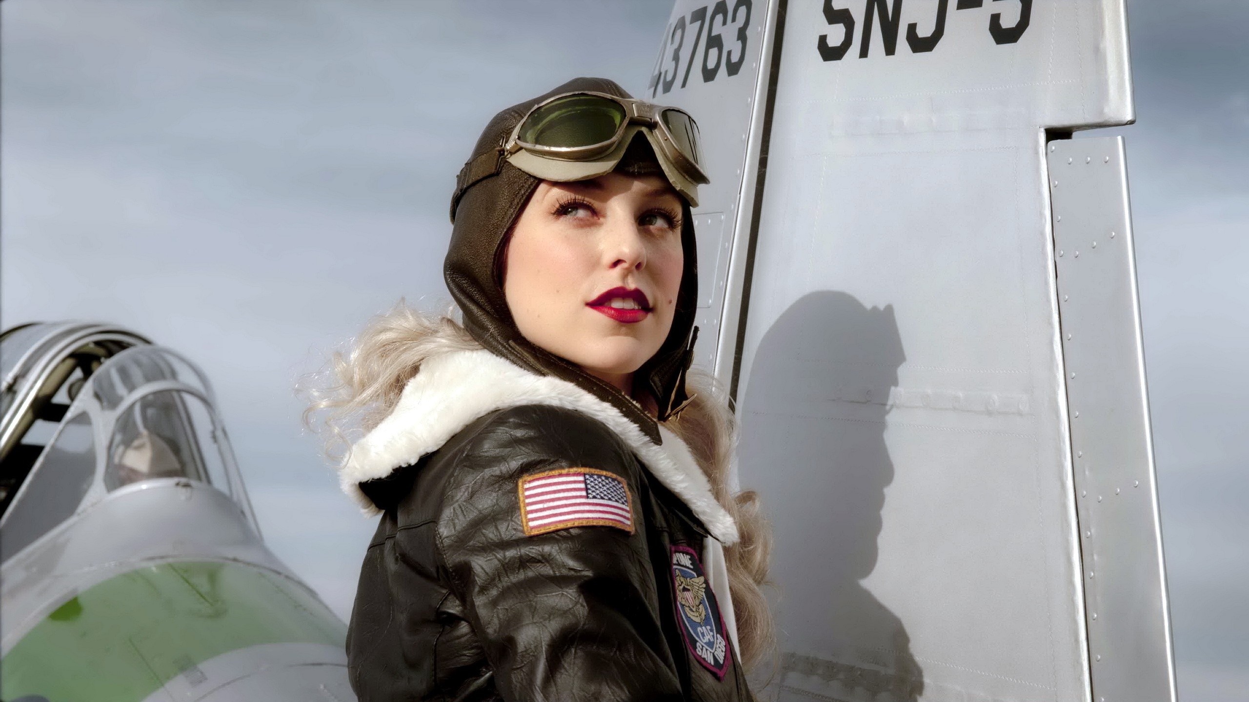 Woman in vintage pilot costume with airplane HD Wallpaper