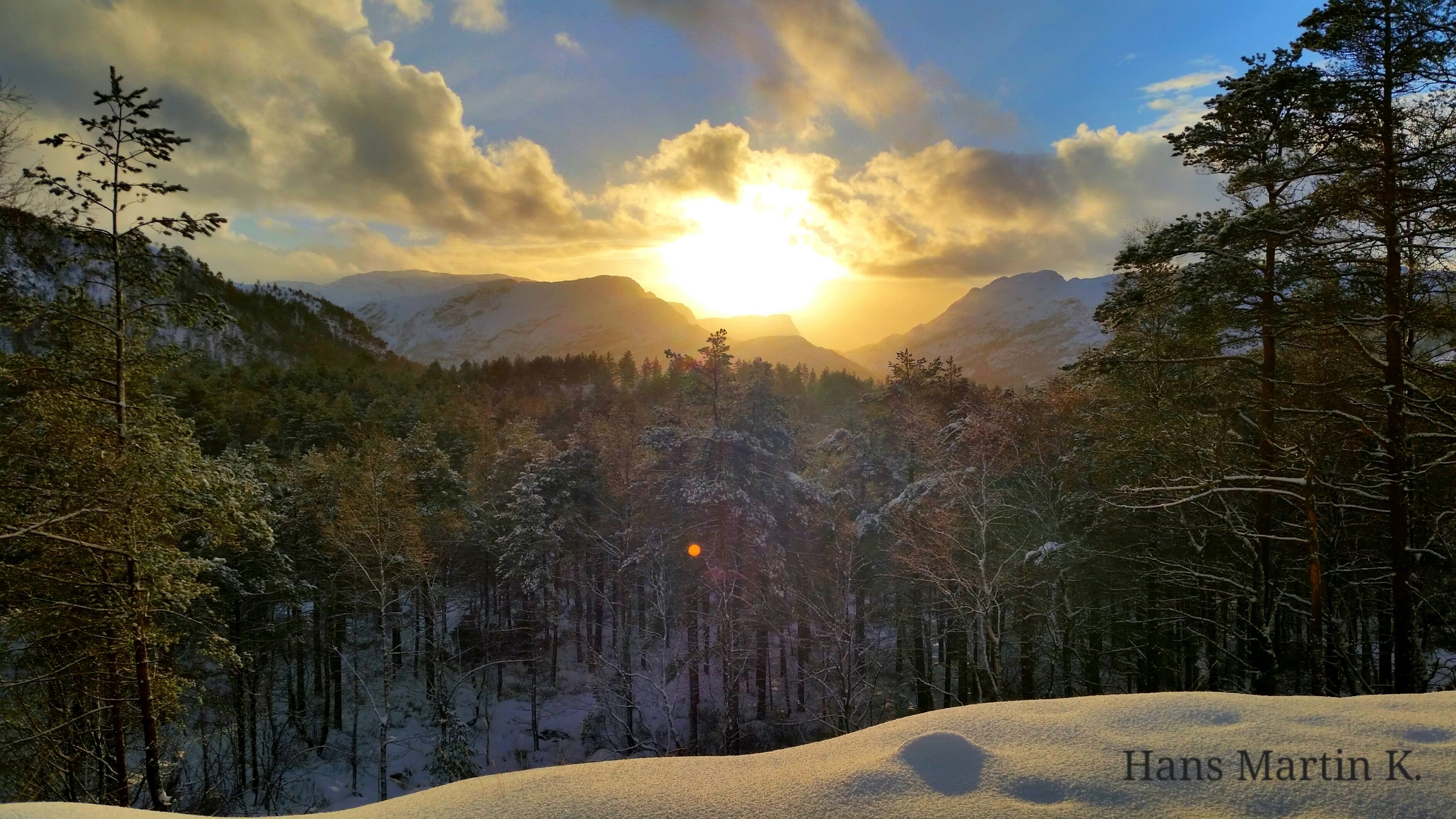 Winter sunset over a snowy forest and mountains in Norway HD Wallpaper