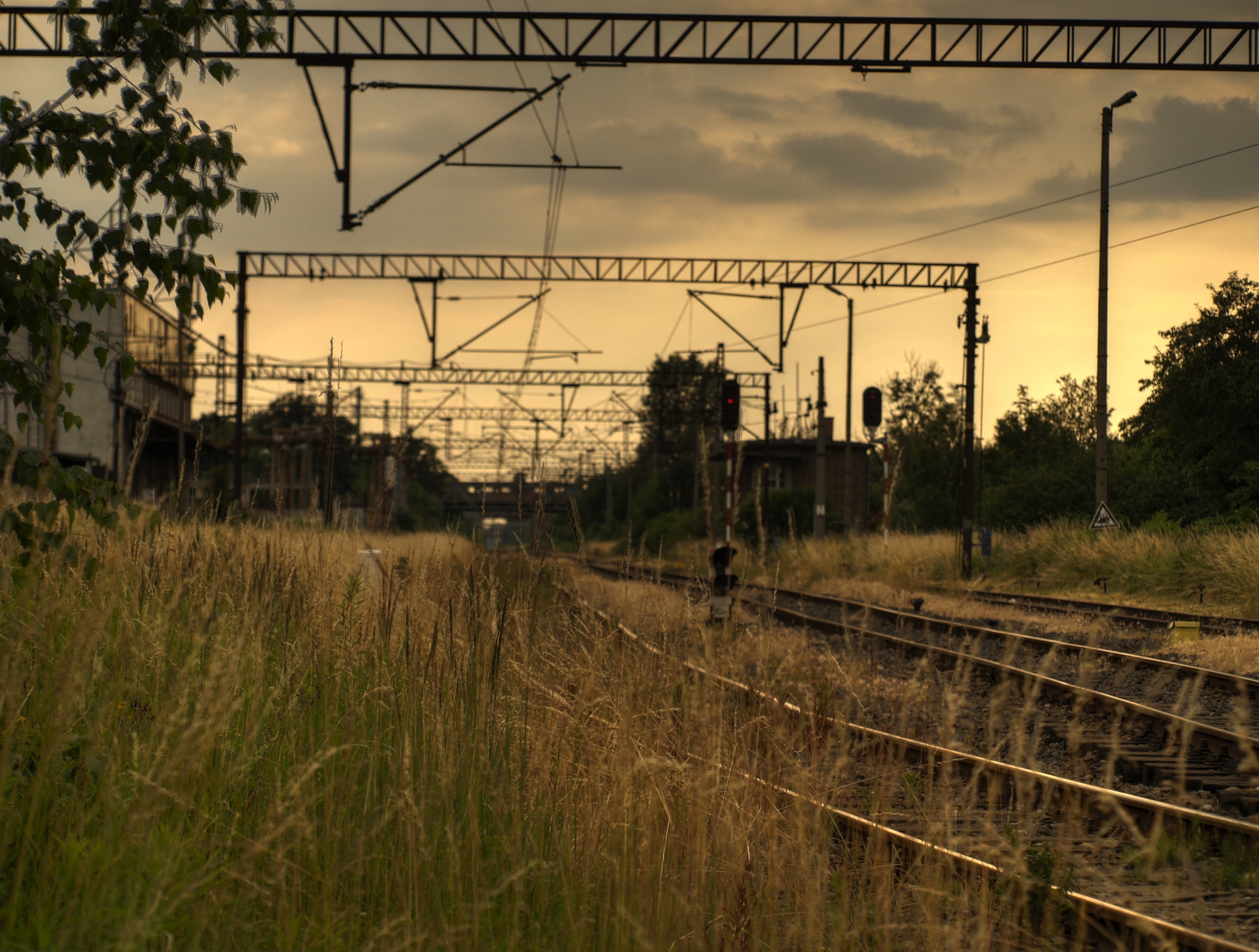 Train tracks and overhead power lines at dusk HD Wallpaper