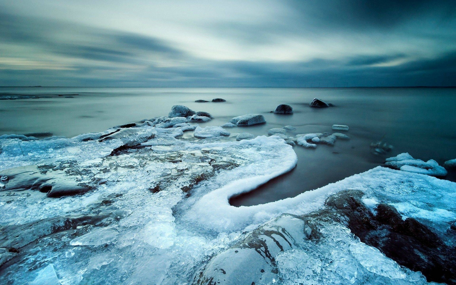 Frozen Shoreline with Ice and Rocks HD Wallpaper