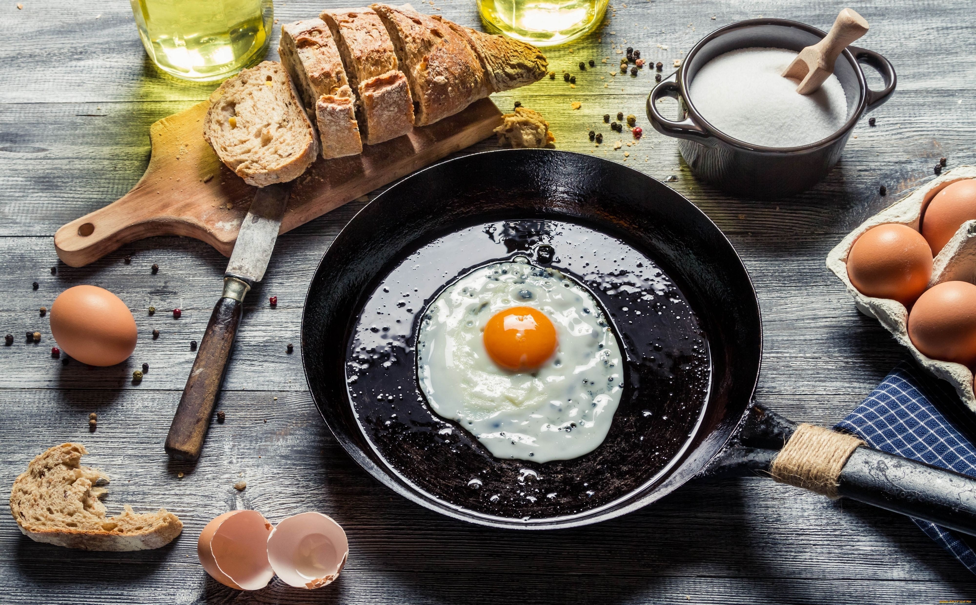 Fried egg in a pan with bread and ingredients HD Wallpaper
