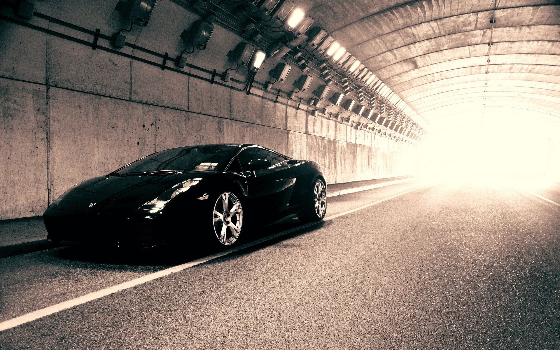 Black Lamborghini sports car in a concrete tunnel HD Wallpaper