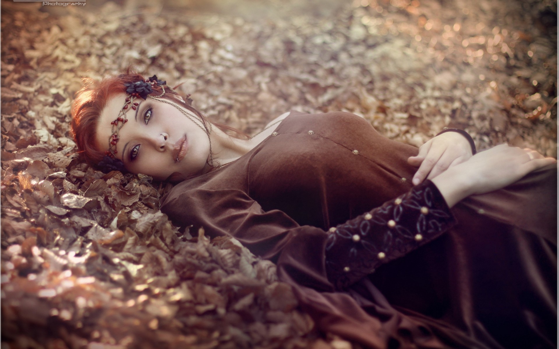 Woman with red hair lying in autumn leaves HD Wallpaper