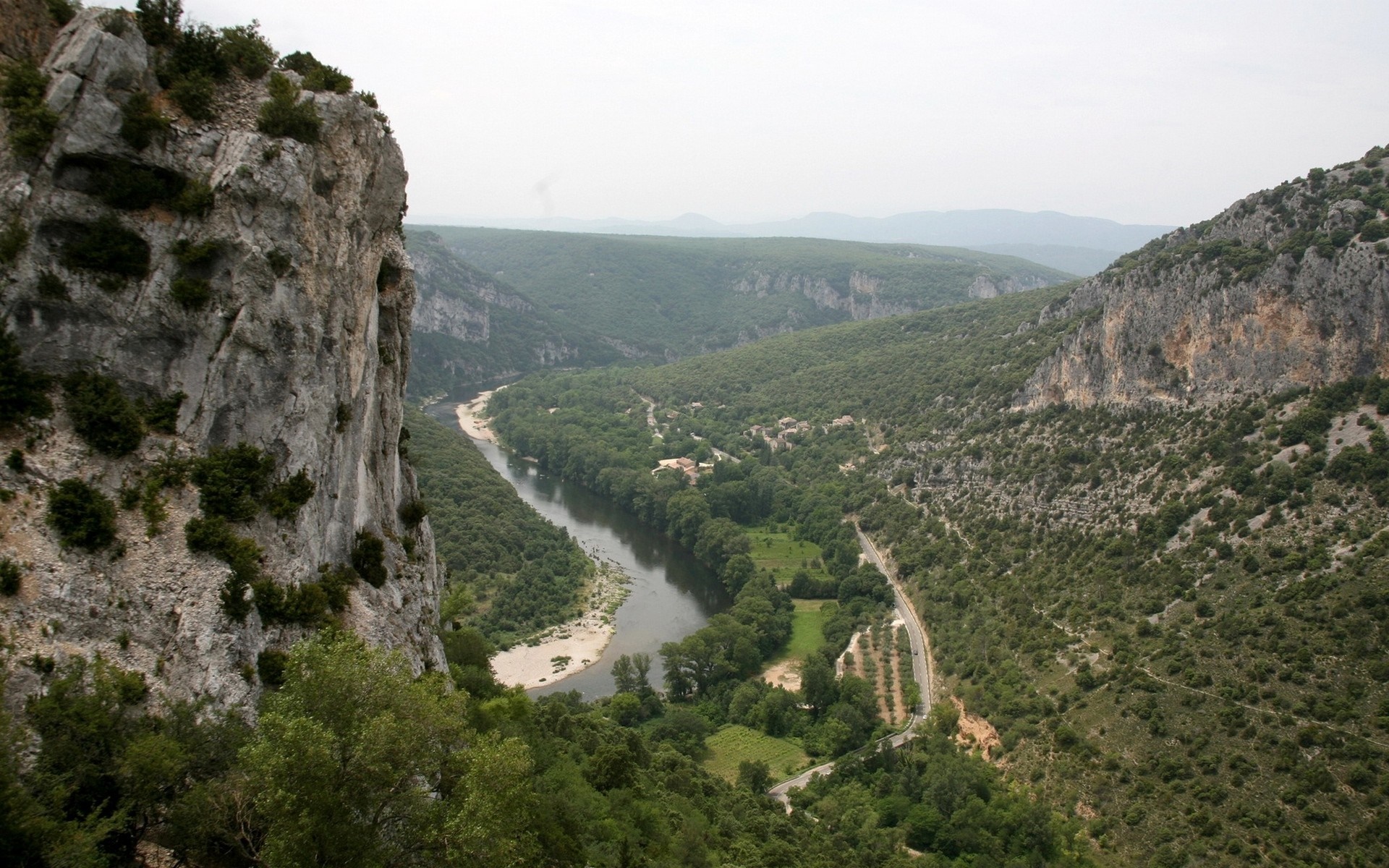 River valley with cliffs and forested mountains HD Wallpaper