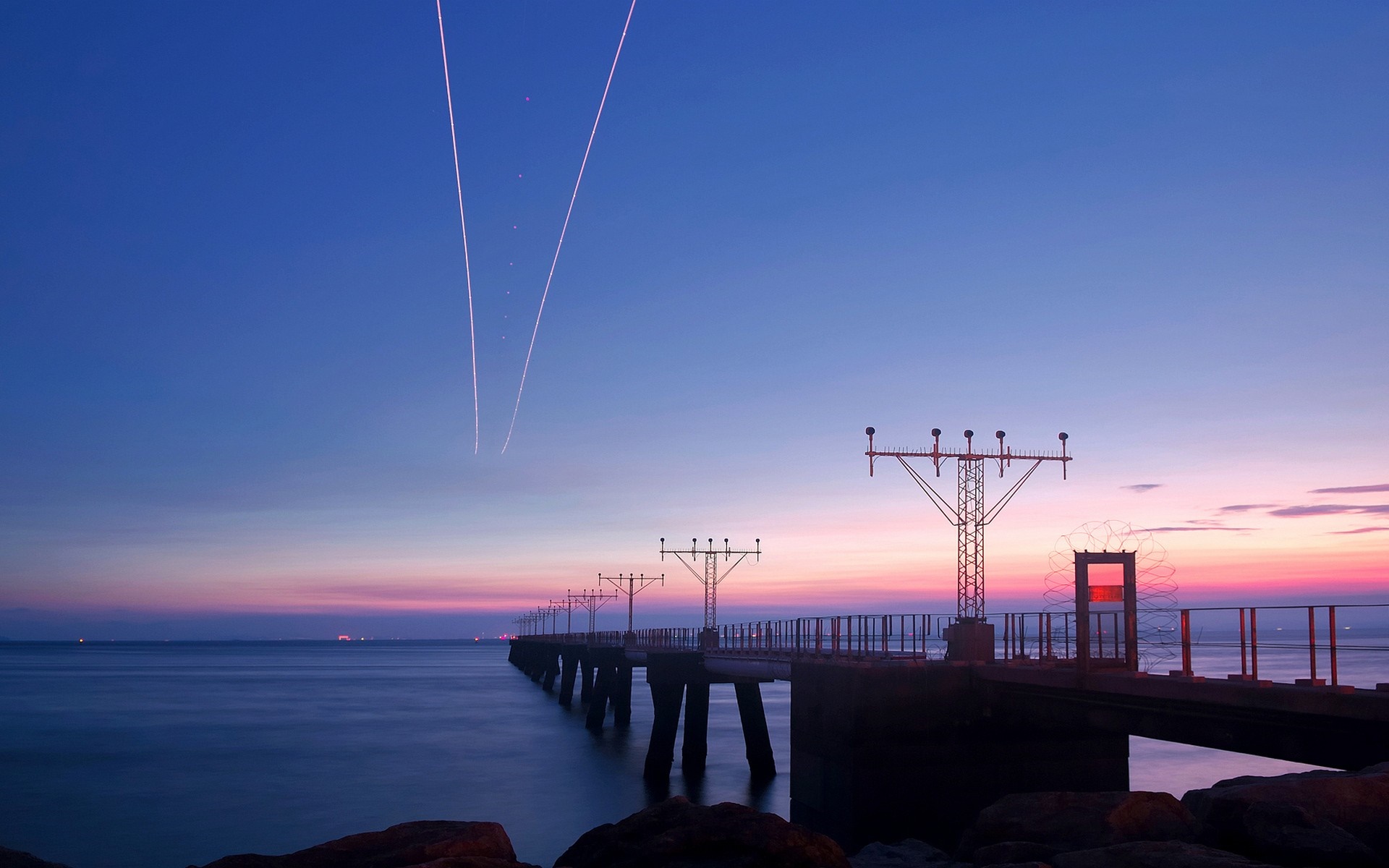 Airport landing lights pier at sunset over the sea HD Wallpaper