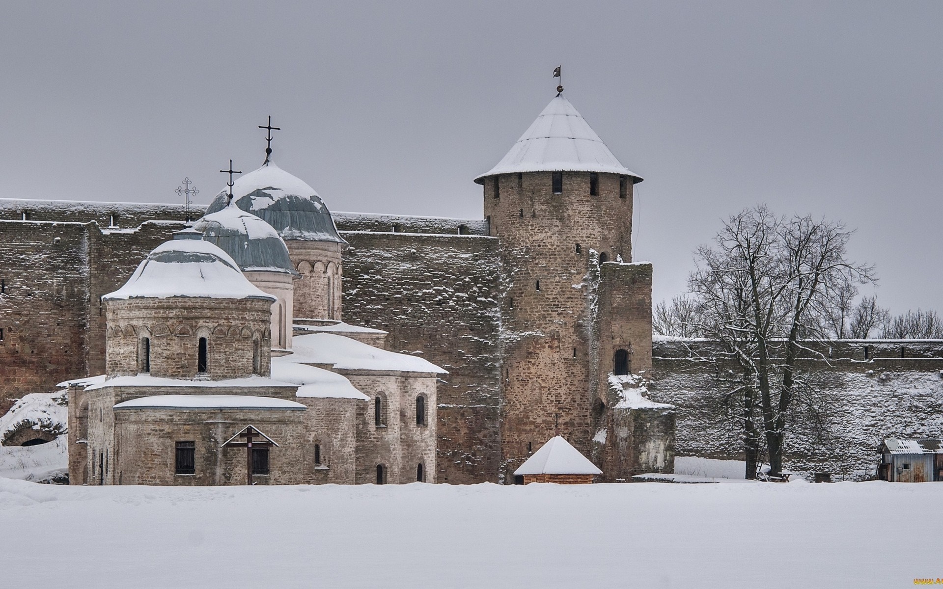 Snowy winter scene of a stone castle with churches and a tower HD Wallpaper