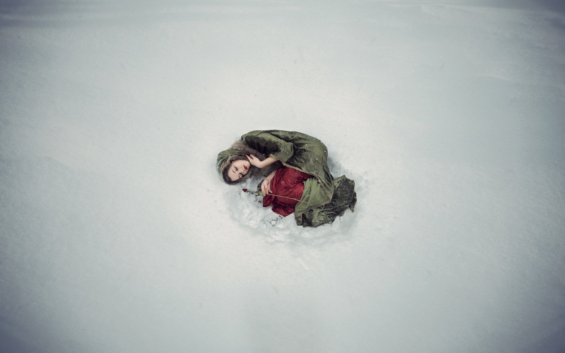 Woman in snow holding a rose HD Wallpaper