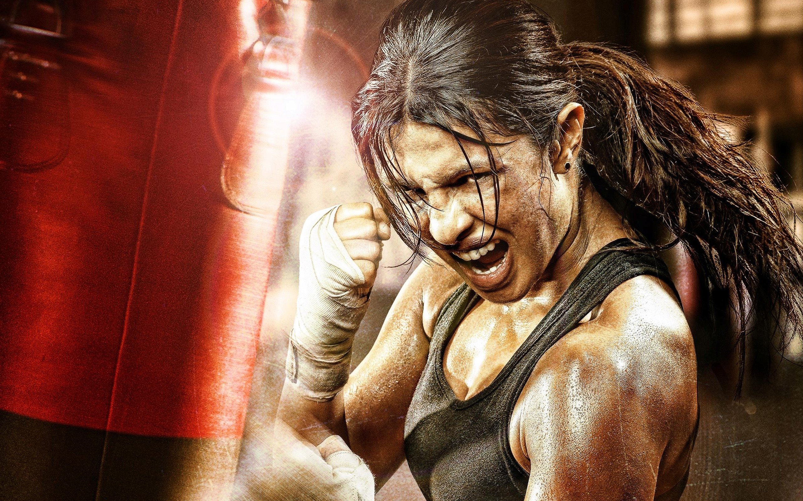 Woman boxing with a punching bag HD Wallpaper