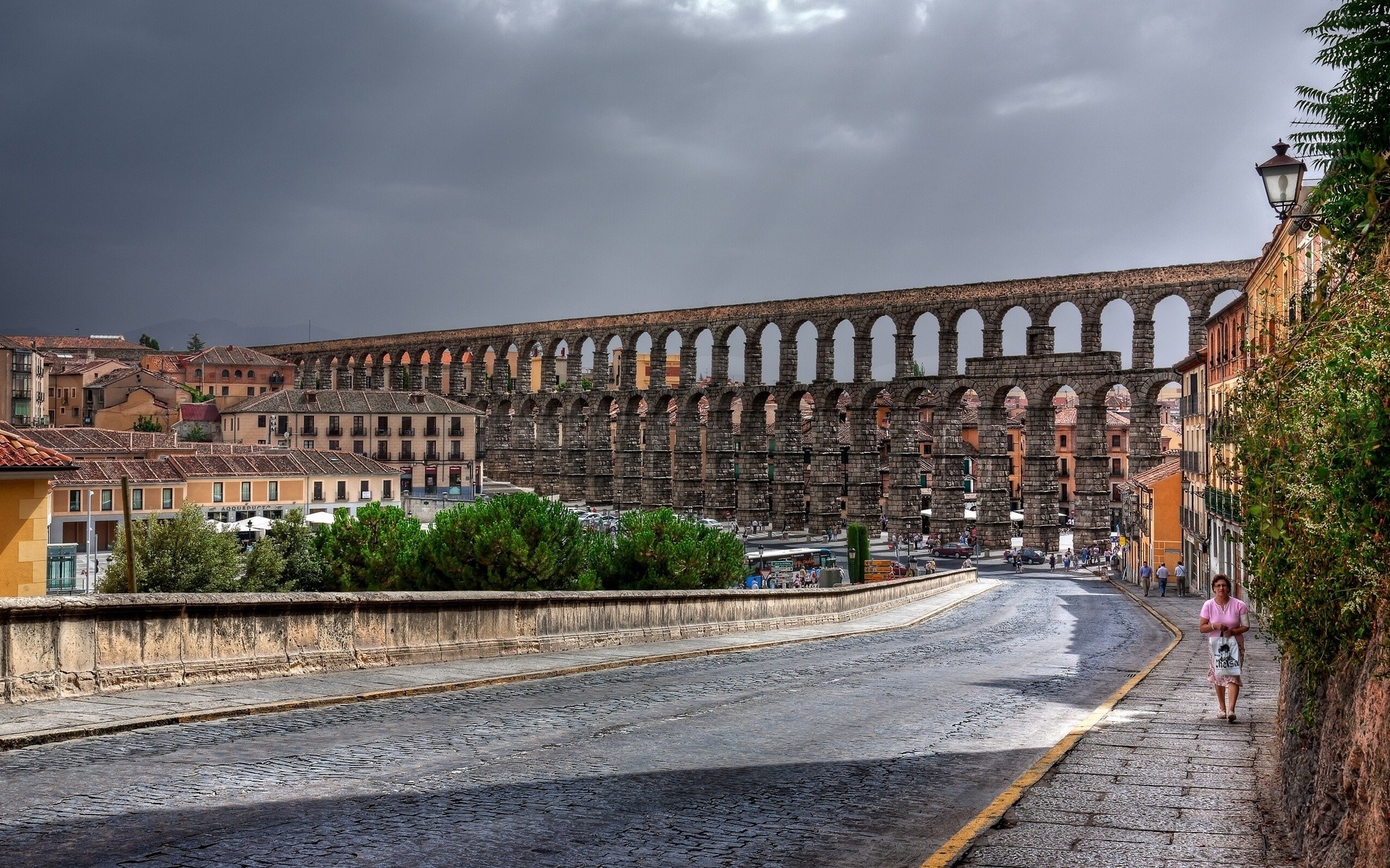 Segovia Aqueduct and street with a woman walking HD Wallpaper