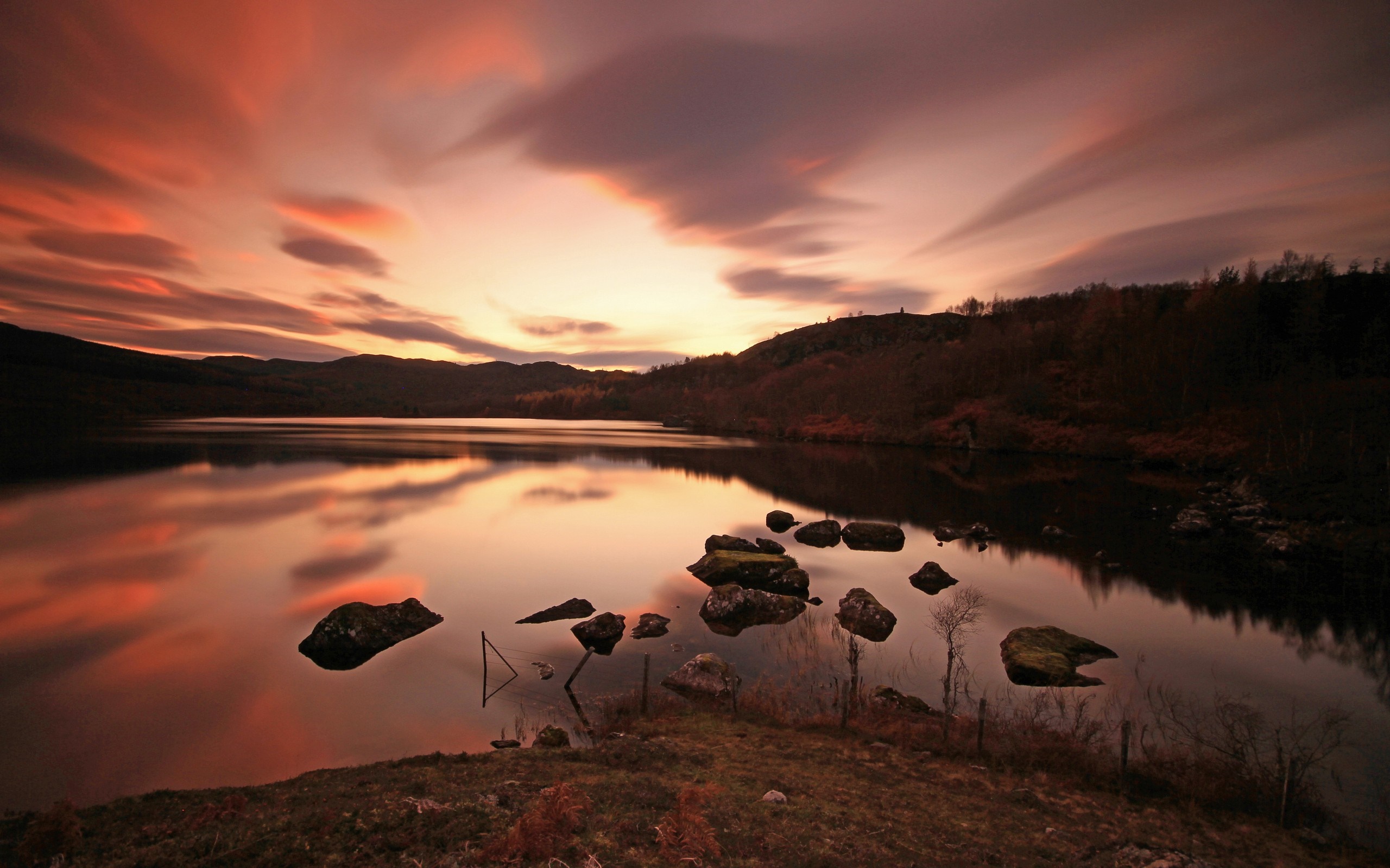 Sunset over a lake with mountains and rocks HD Wallpaper
