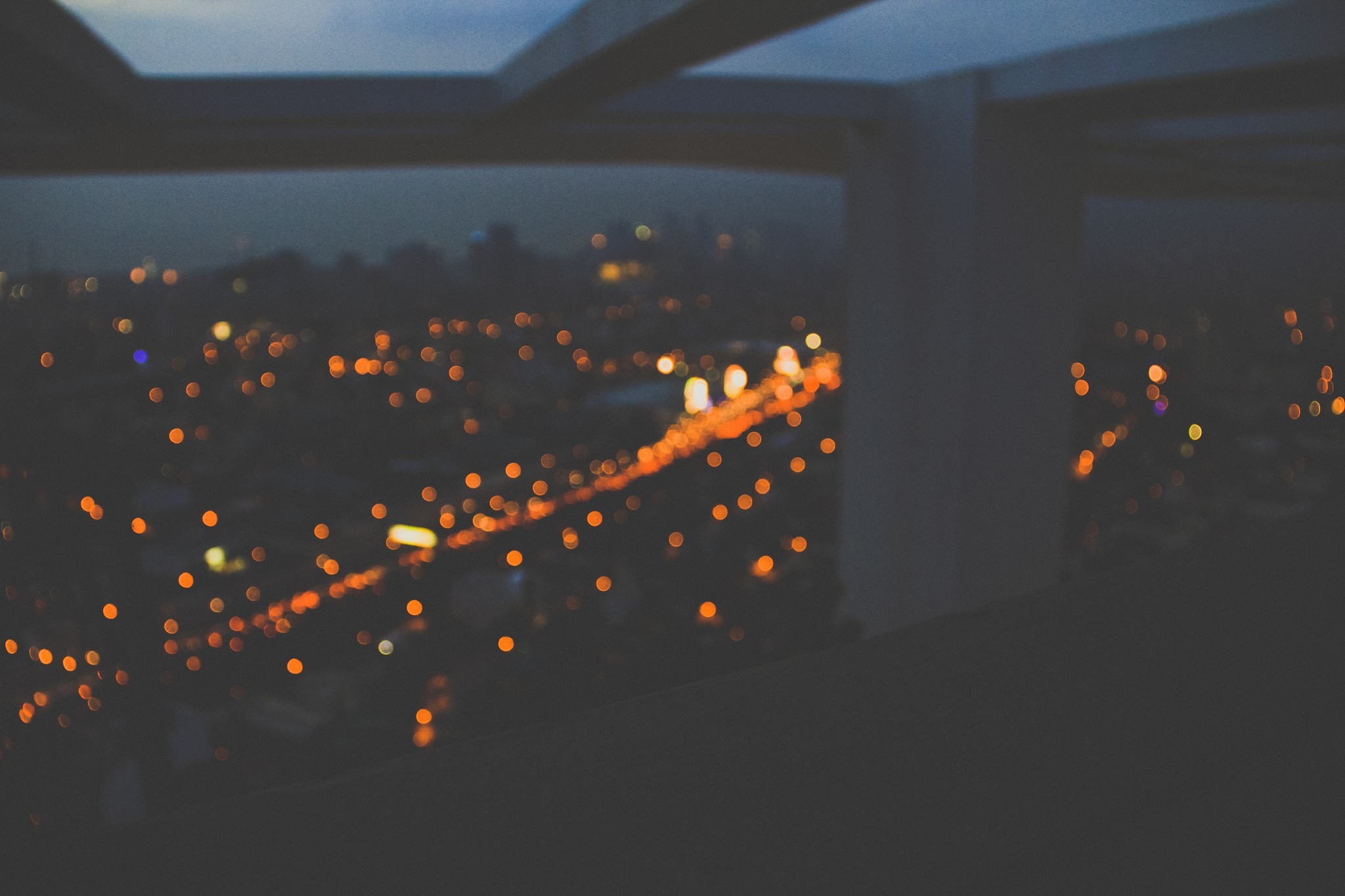 Blurred cityscape at night with orange lights HD Wallpaper