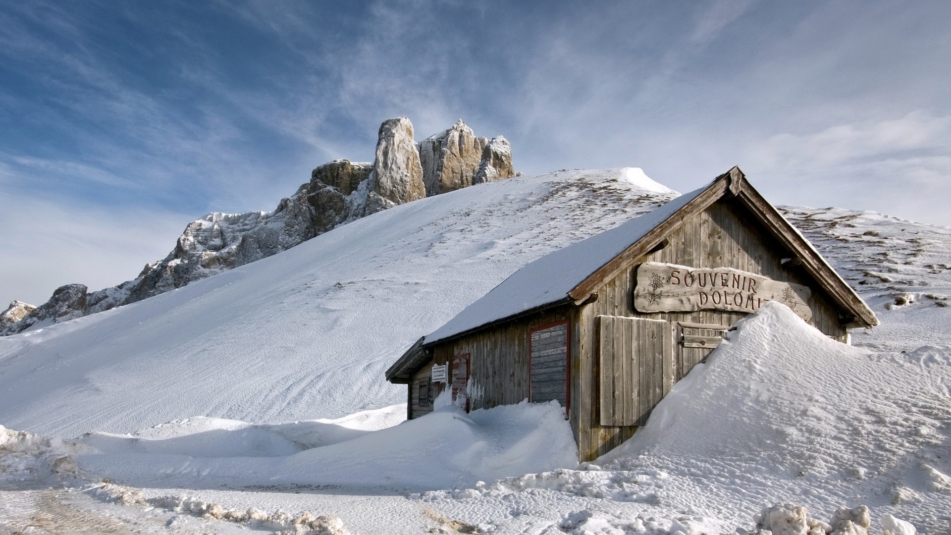 Wooden cabin in the snow with Dolomite mountains HD Wallpaper