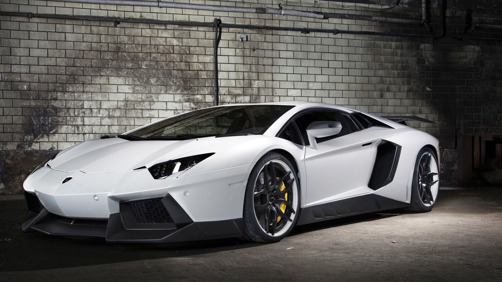 White Lamborghini Aventador parked in front of a brick wall HD Wallpaper