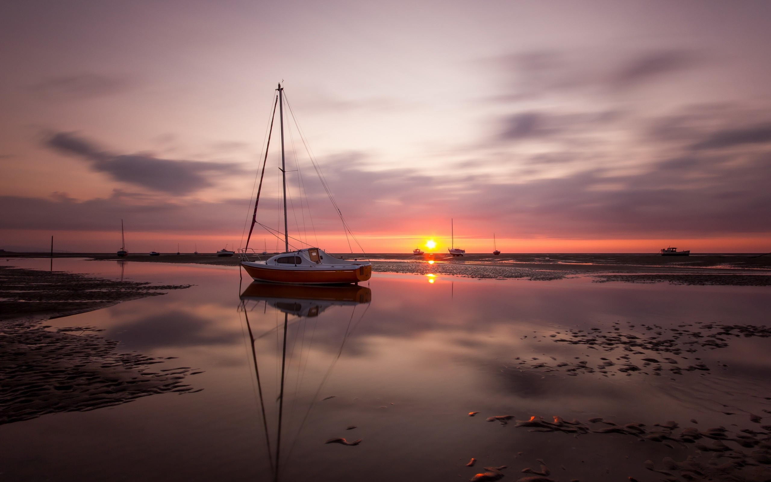 Sailboat on a calm sea at sunset with reflections HD Wallpaper