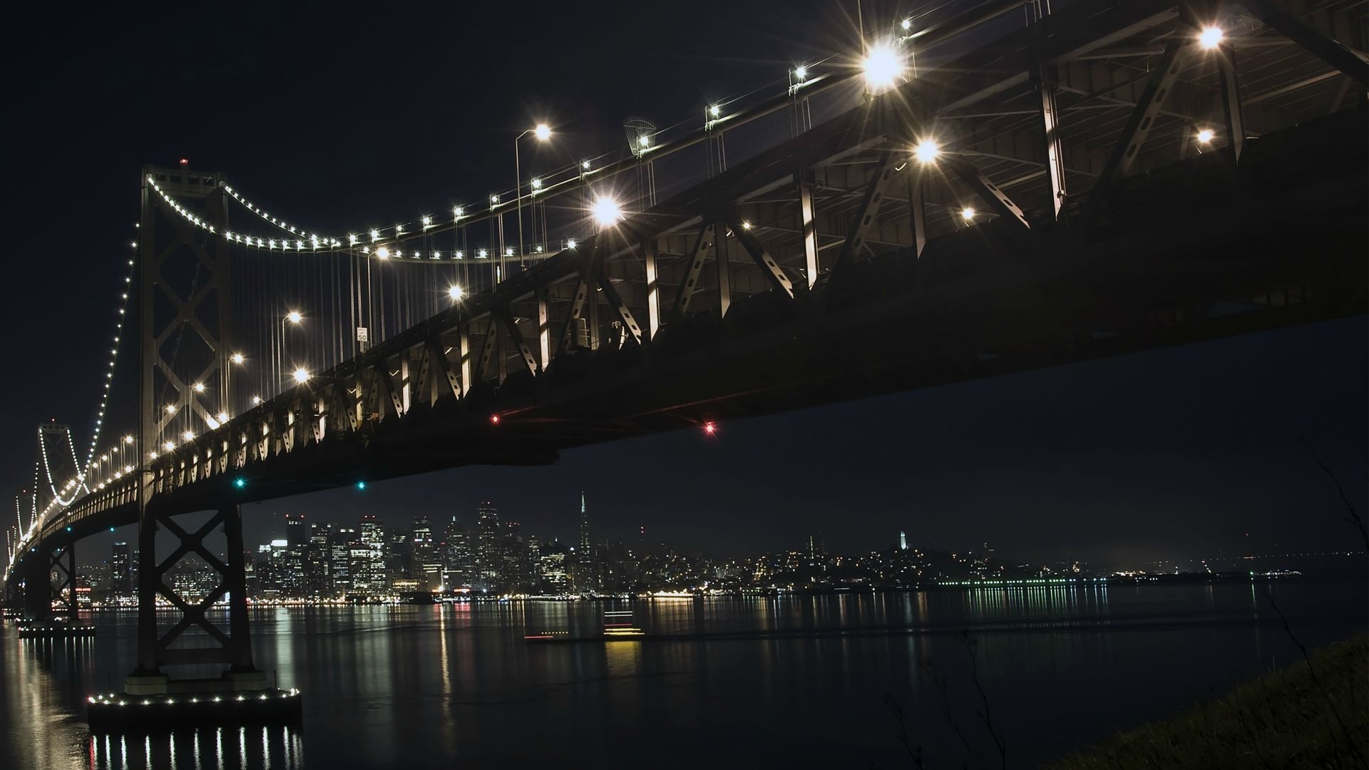 Oakland Bay Bridge at night with San Francisco cityscape HD Wallpaper