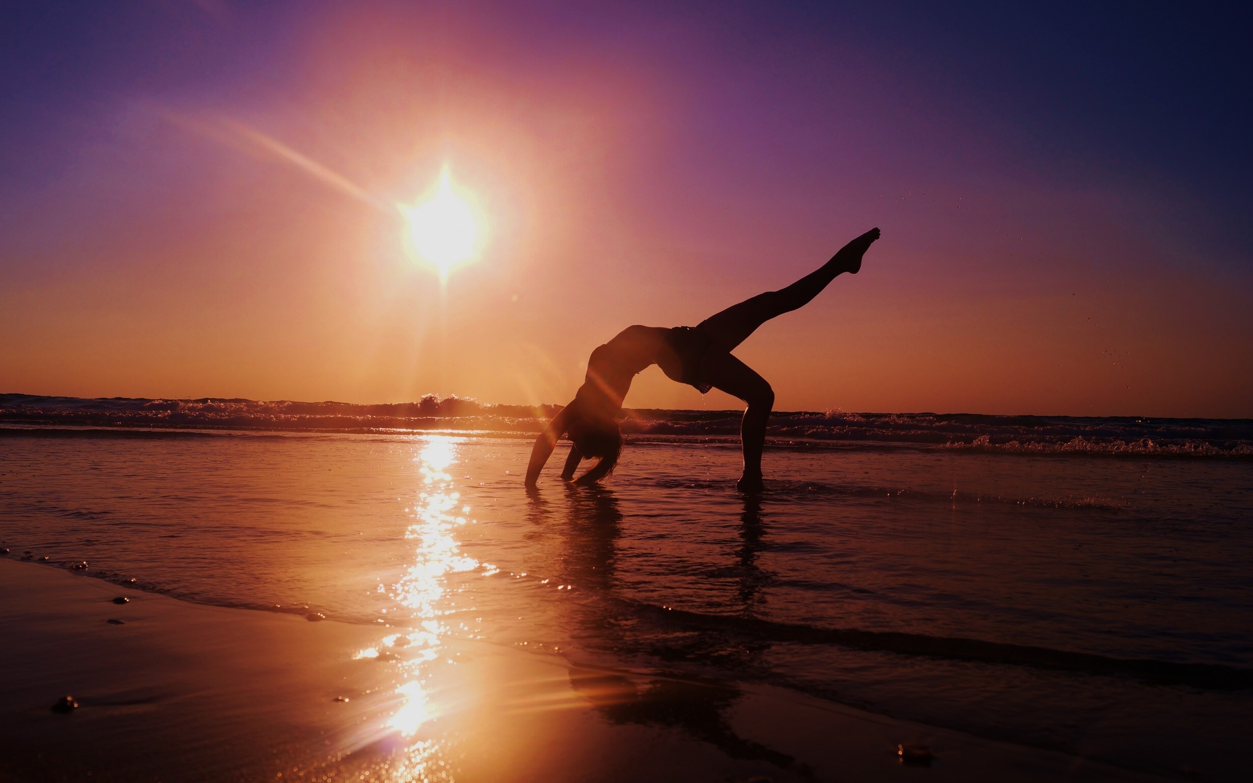 Woman doing a backbend on a beach at sunset HD Wallpaper