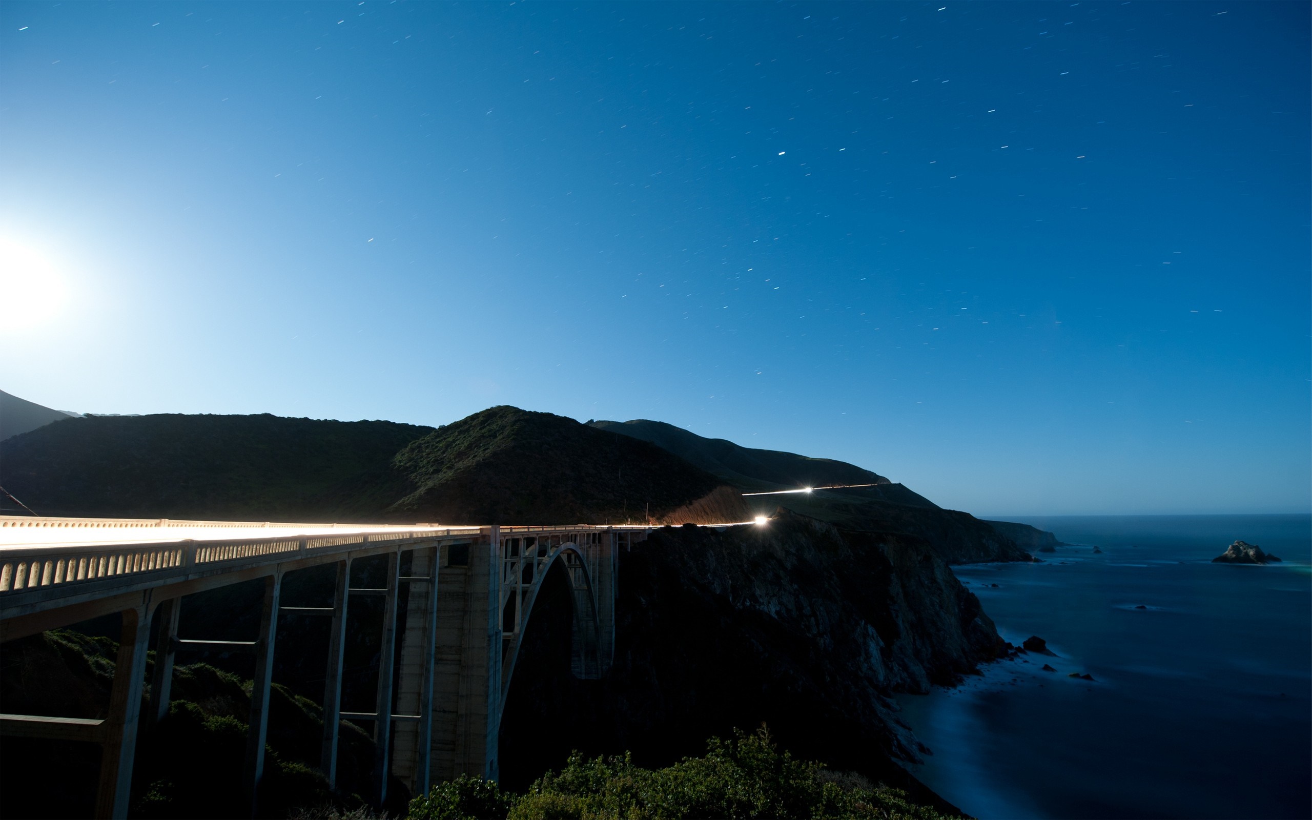 Bixby Bridge at night with ocean and mountains HD Wallpaper