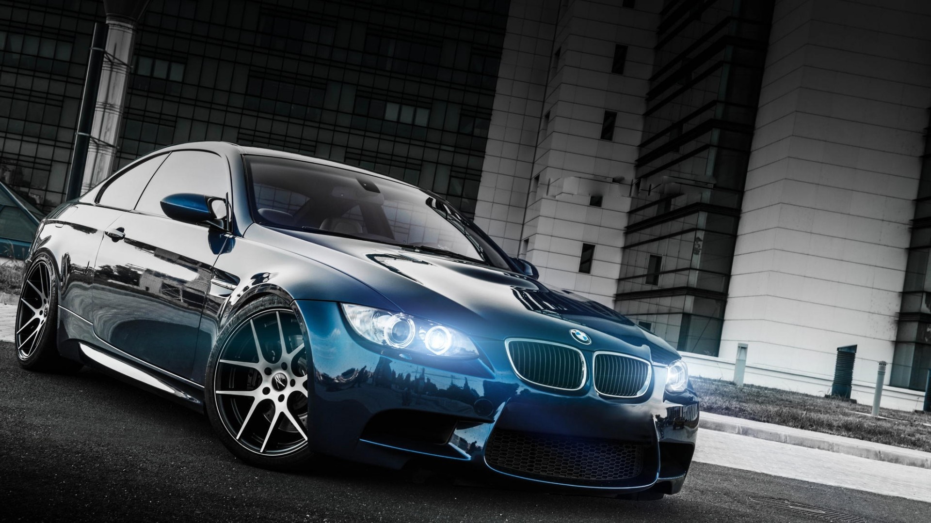 Blue BMW M3 Coupe parked in front of modern buildings HD Wallpaper